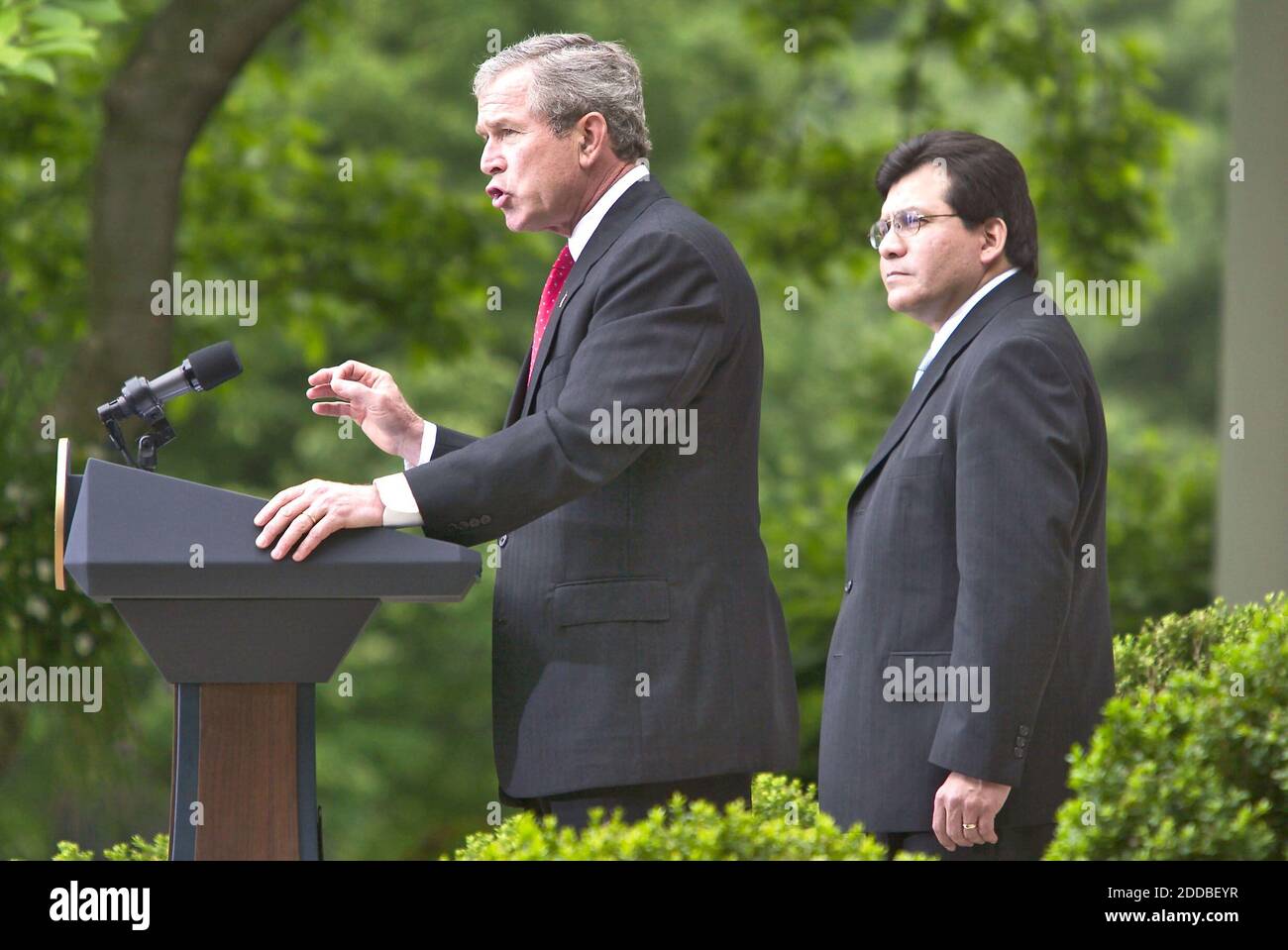 NO FILM, NO VIDEO, NO TV, NO DOCUMENTARY - U.S. President George W. Bush makes remarks on Judicial Independence and the Judicial Confirmation Process as White House Counsel Alberto Gonzales looks on from the Rose Garden at The White House in Washington, D.C. on Friday, May 9, 2003.President Bush has chosen White House counsel Alberto Gonzales, a Texas confidant and the most prominent Hispanic in the administration, to succeed Attorney General John Ashcroft. November 10, 2004. Photo by Chuck Kennedy/KRT/ABACA. Stock Photo