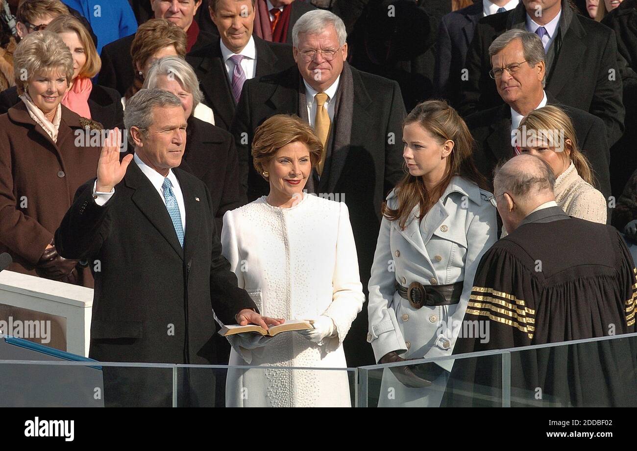 NO FILM, NO VIDEO, NO TV, NO DOCUMENTARY - U.S. President George W. Bush takes the Oath of Office from Supreme Court Justice William Rehnquist during Inauguration ceremonies on Capitol Hill in Washington, January 20. 2005, as First Lady Laura Bush, center, looks on with daughters Barbara, seconf from right and Jenna, right. Washington, DC, USA, on January 20, 2005. Photo by George Bridges/US News Story Slugged/KRT/ABACA. Stock Photo