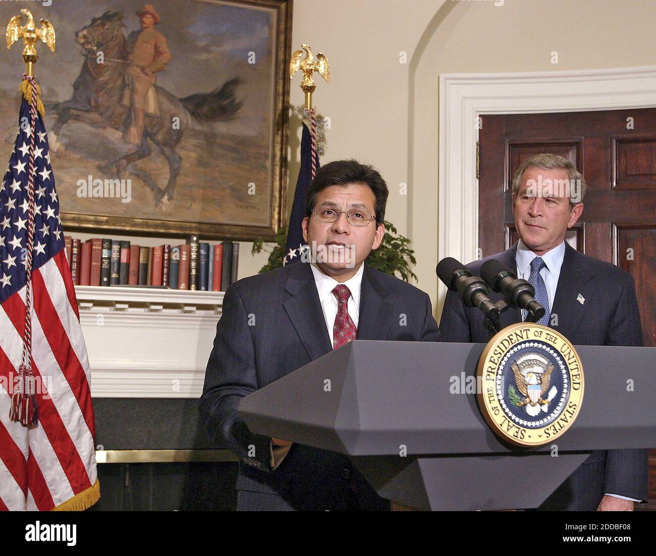 NO FILM, NO VIDEO, NO TV, NO DOCUMENTARY - White Counsel Alberto Gonzales, left, speaks to the media after being nominated by President George W. Bush, right, to fill the spot of U.S. Attorney General to replace John Ashcroft. (gsb) 2004. Photo by Chuck Kennedy/KRT/ABACA. Stock Photo