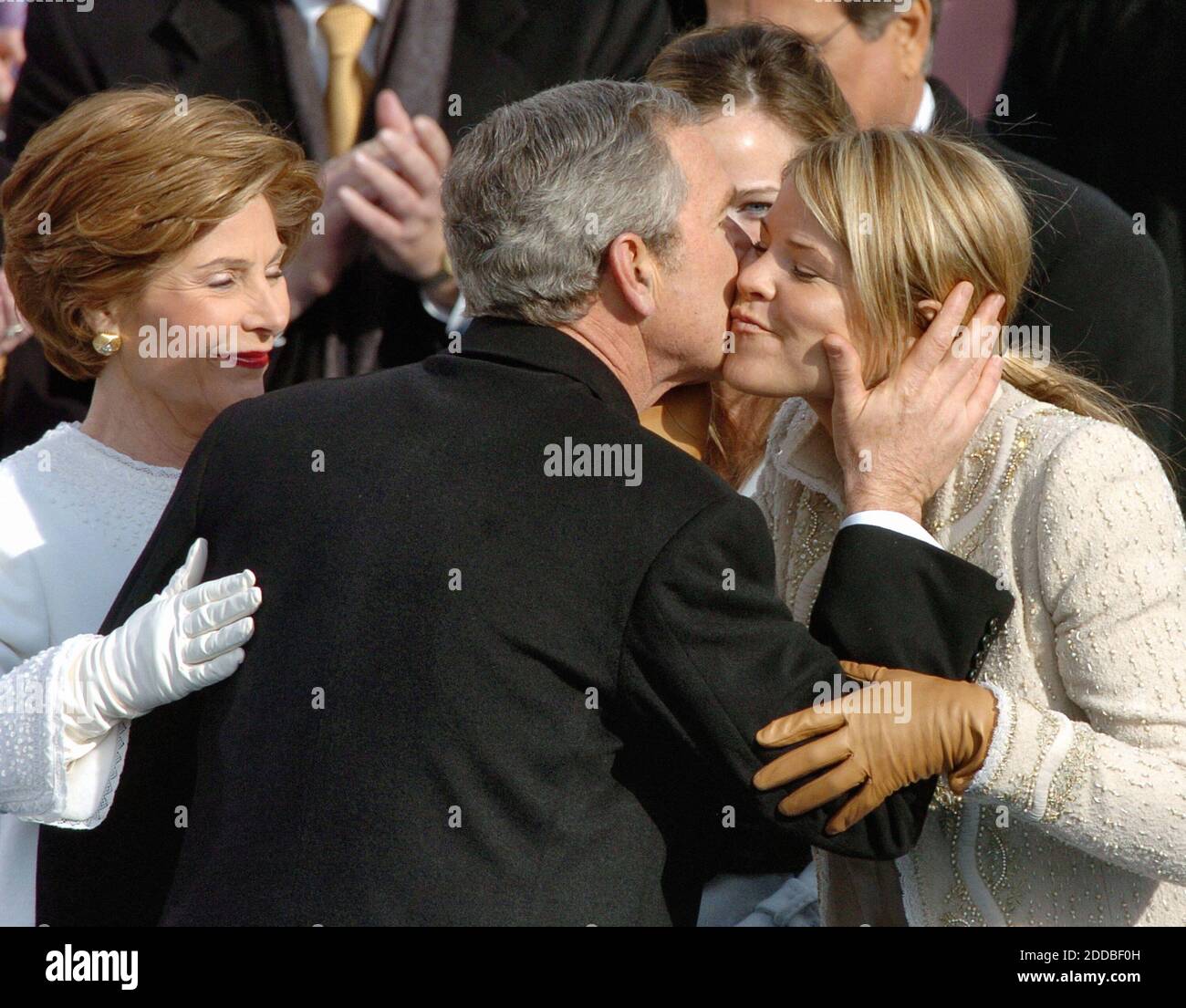 NO FILM, NO VIDEO, NO TV, NO DOCUMENTARY - President George W. Bush kisses daughter Jenna, right, as First Lady Laura Bush, left, looks on, after being sworn in as U.S. Preident for a second term. Washington, DC, USA, on January 20, 2005. Photo by George Bridges/US News Story Slugged/KRT/ABACA. Stock Photo