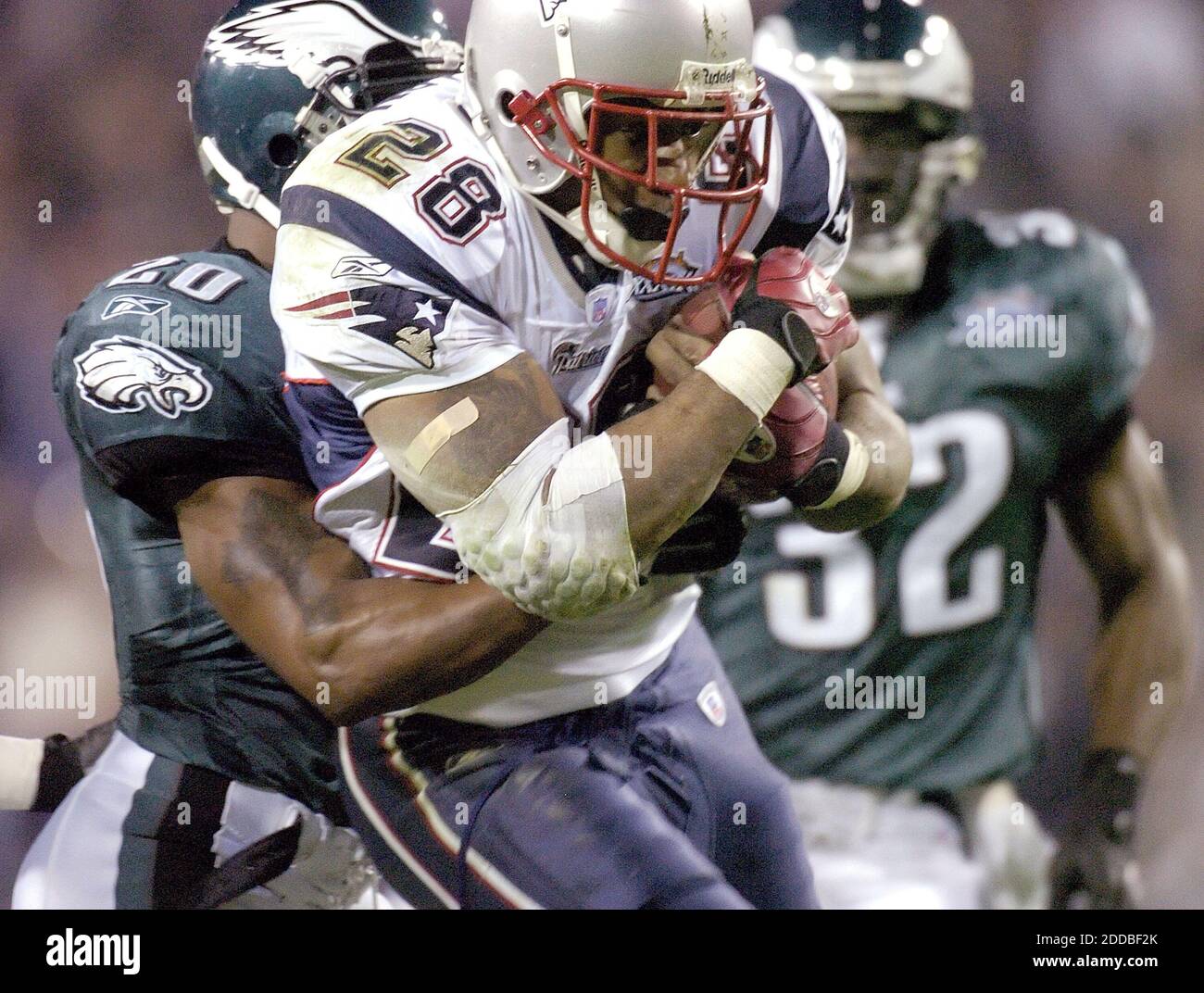NO FILM, NO VIDEO, NO TV, NO DOCUMENTARY - New England's Corey Dillon (28) is wrapped up by Philadelphia's Brian Dawkins (20) in the second quarter of Super Bowl XXXIX on Sunday, February 6, 2005. Photo by Eric Mencher/Philadelphia Inquirer/KRTCameleon/ABACA. Stock Photo
