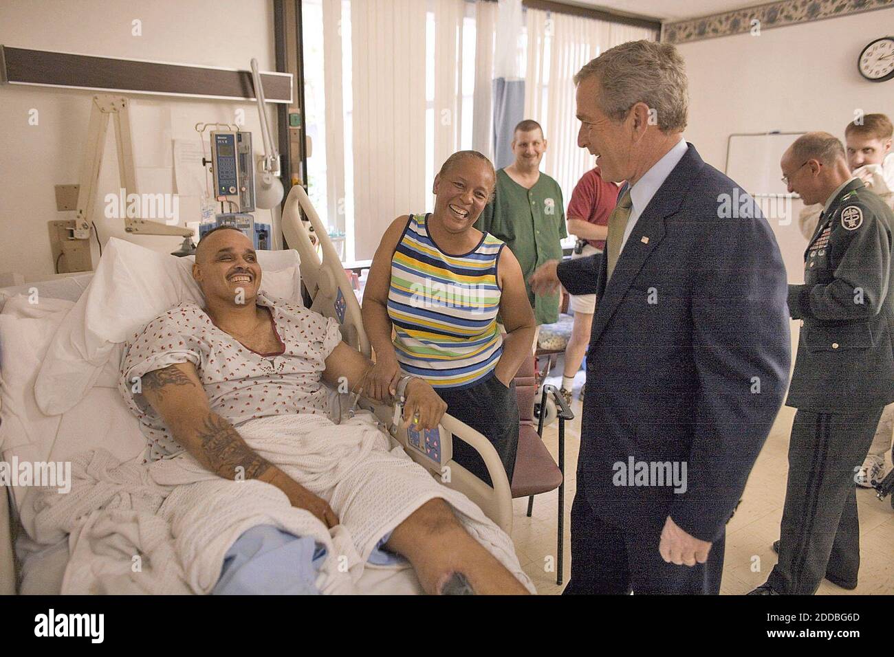 NO FILM, NO VIDEO, NO TV, NO DOCUMENTARY - President George W. Bush visits with Sgt. John Iverson and his wife, Pamela, during the president's visit to Walter Reed Army Medical Center on Friday, July 1, 2005. The soldier, from Long Beach, California, is recovering from injuries sustained while serving in Iraq. Photo by Eric Draper/White House/KRT/ABACAPRESS.COM Stock Photo