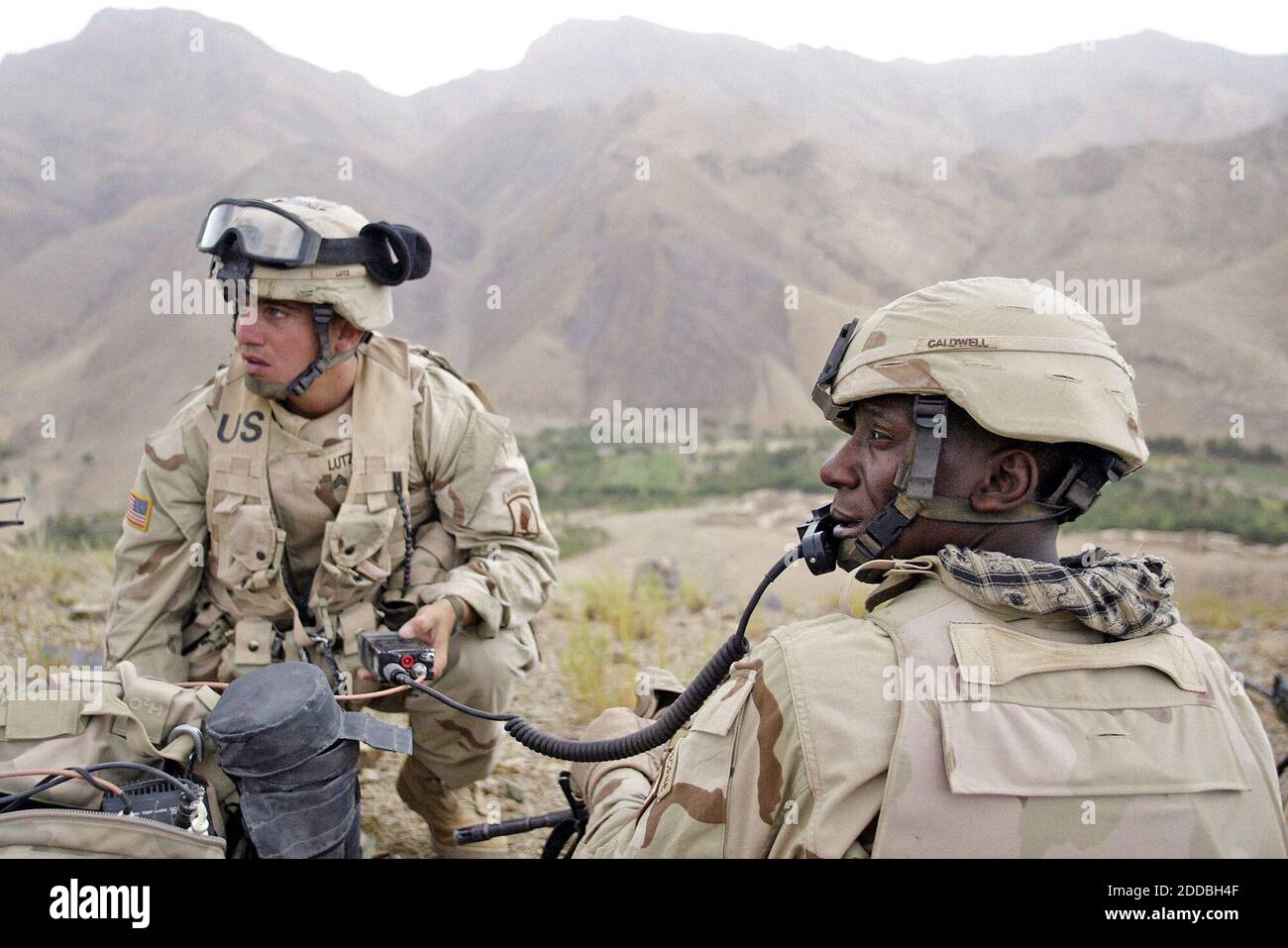 NO FILM, NO VIDEO, NO TV, NO DOCUMENTARY - Sgt. Jay Lutz, from Jarettsville, Maryland (L), and 1st Sgt. La Monta Caldwell, from Ruston Louisiana, with Battle Company, 2nd Batt. Airborne, 503rd Infantry, 173rd Airborne Brigade, monitor the radio traffic while participating in Operation Como in the Deh Chopan District of Zabul Province, Afghanistan, on August 10, 2005. Photo by Tom Pennington/Fort Worth Star-Telegram/KRT/ABACAPRESS.COM. Stock Photo