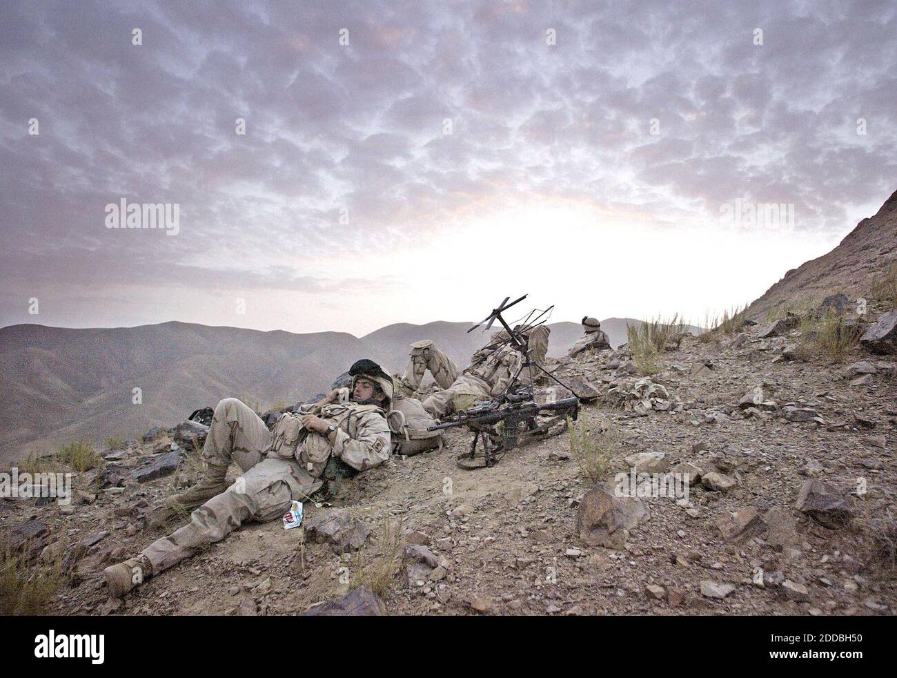 NO FILM, NO VIDEO, NO TV, NO DOCUMENTARY - Soldiers from Battle Company, 2nd Batt. Airborne, 503rd Infantry, 173rd Airborne Brigade monitor the radio traffic as the sun goes down high in the mountains while participating in Operation Como in the Deh Chopan District of Zabul Province, Afghanistan, on August 10, 2005. Photo by Tom Pennington/Fort Worth Star-Telegram/KRT/ABACAPRESS.COM. Stock Photo