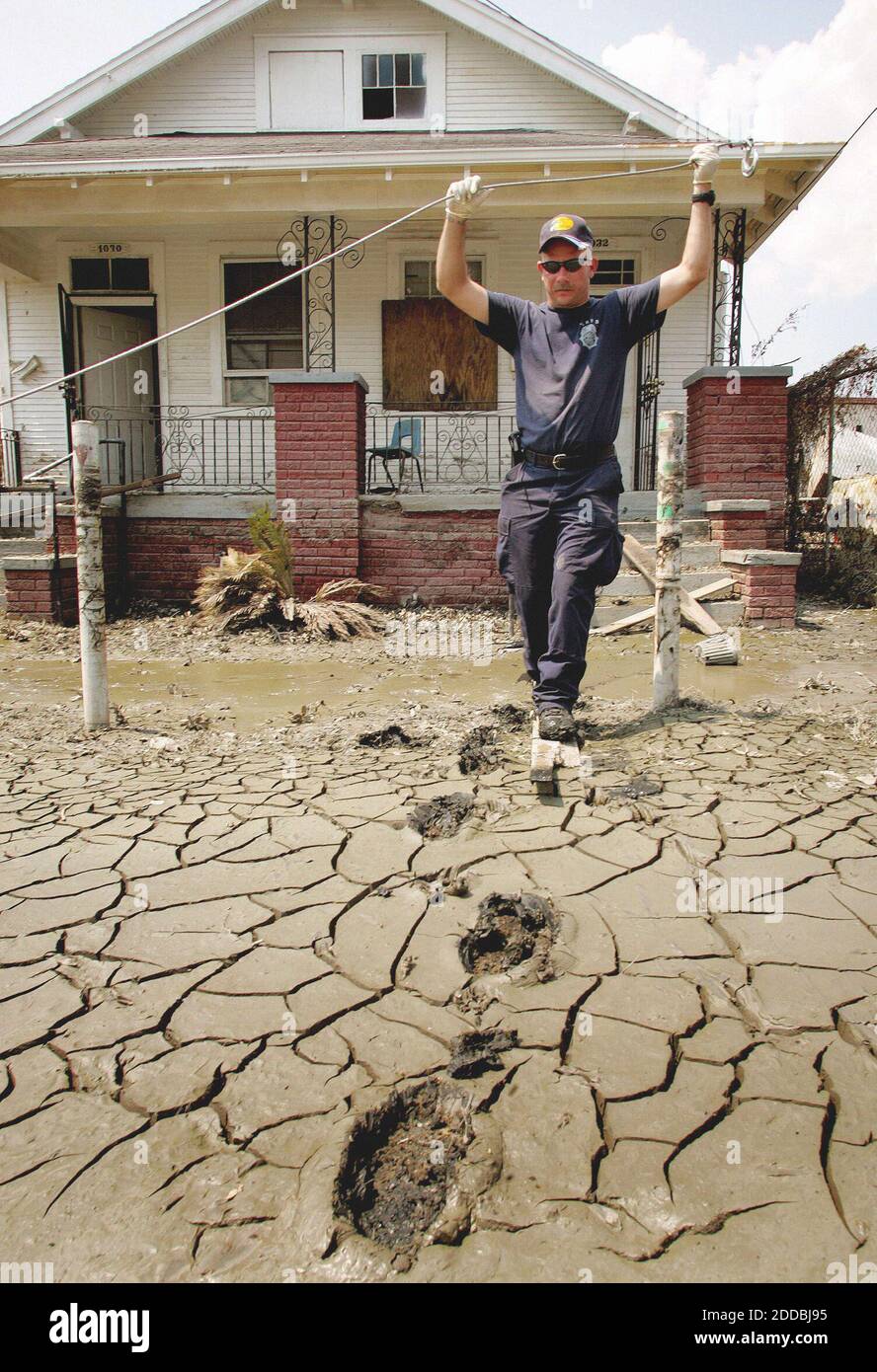 NO FILM, NO VIDEO, NO TV, NO DOCUMENTARY - Scott Chassells of the North Little Rock Fire Department walks through mud while conducting a house-to-house search in the lower ninth ward of New Orleans, Louisiana, on Saturday, Sept. 10, 2005. Hurricane Katrina devasted. Hurricane Katrina left the city devastated. Photo by Khamphanh/Forthworth Star-Telegram/KRT/ABACAPRESS.COM Stock Photo