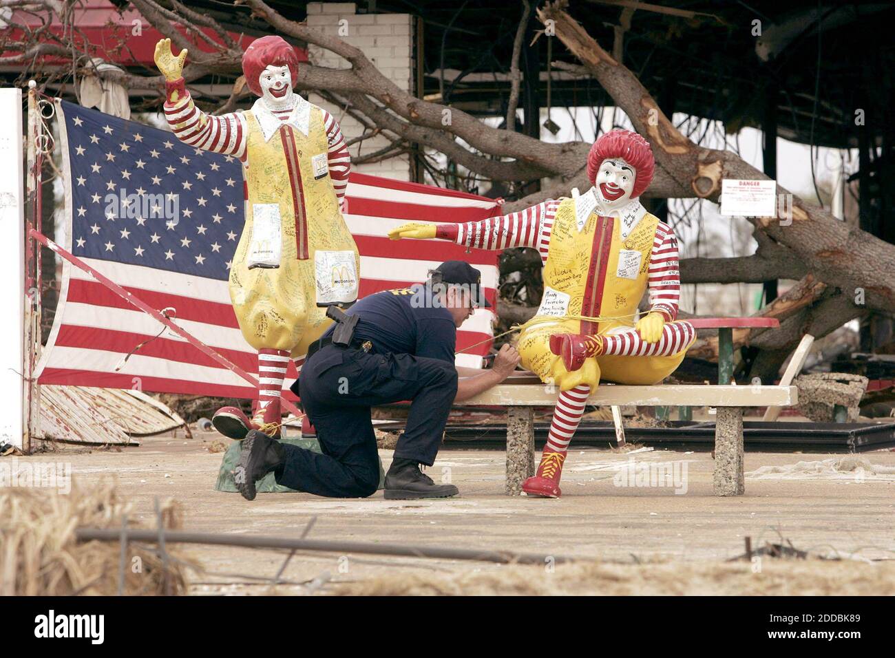 NO FILM, NO VIDEO, NO TV, NO DOCUMENTARY - Police officer Vinny Cassidy, from Jacksonville, Florida, signs a Ronald McDonald statue on Wedesday, September 28, 2005 in Biloxi, Mississippi. Although the statues withstood the assault from Hurricane Katrina, the restaurant was destroyed. Photo by Mark Cornelison/LexingtonHerald/KRT/ABACAPRESS.COM Stock Photo