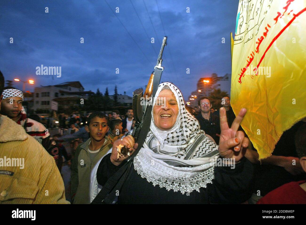 NO FILM, NO VIDEO, NO TV, NO DOCUMENTARY - A Palestinian woman from Fatah holds up gun, and chants slogans during a protest in front of president house Mahmoud Abbas, during a protest in Gaza City, Saturday, January 28, 2006. Fatah gunmen and Palestinian police, angry at Hamas's election victory, briefly took over parliament buildings in the West Bank and Gaza Strip on Saturday, firing in the air, witnesses said. Photo by Ahmad Khateib/Flash 90/KRT/ABACAPRESS.COM Stock Photo