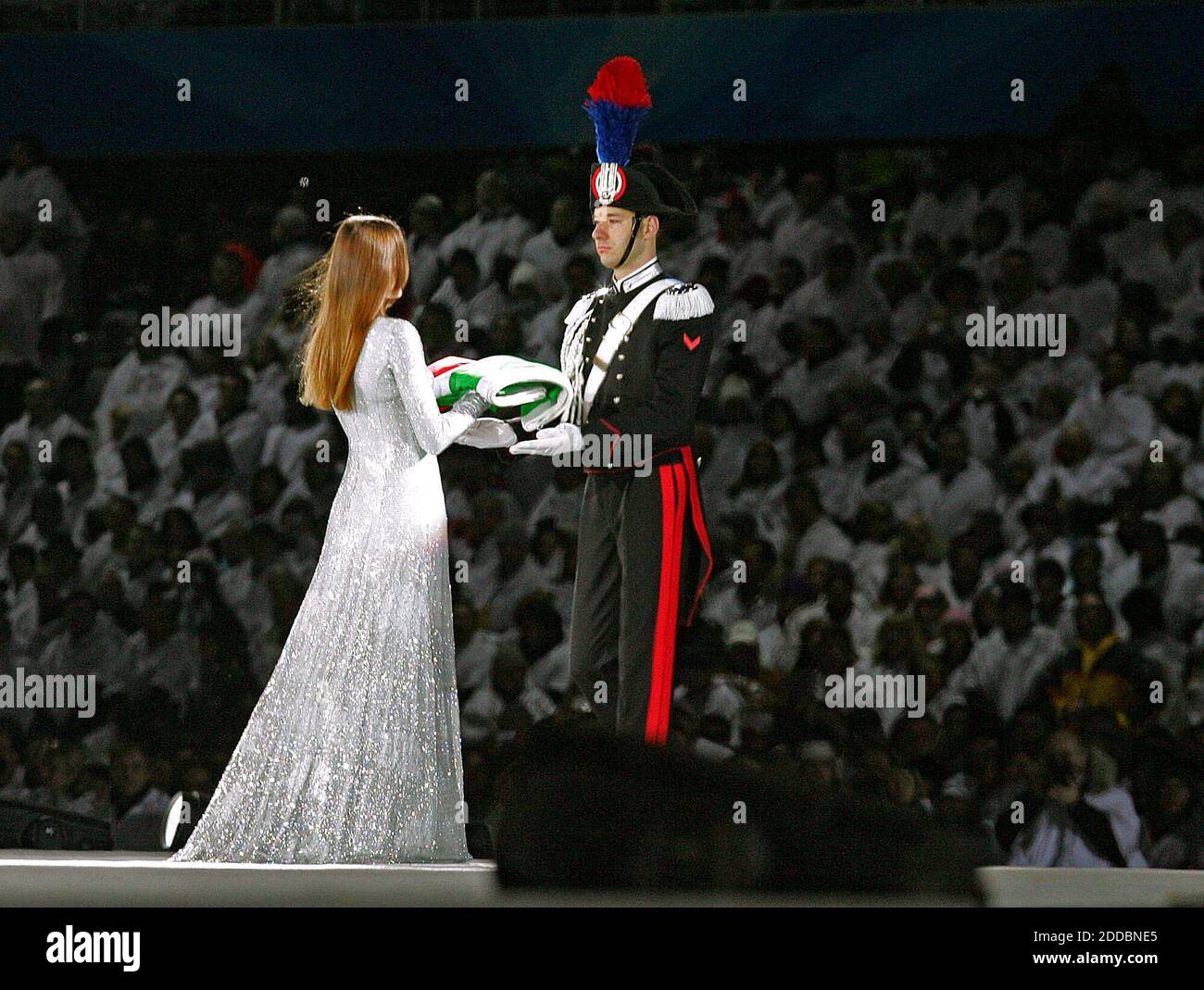 NO FILM, NO VIDEO, NO TV, NO DOCUMENTARY - Turin born former supermodel Carla Bruni carries the Italian flag to a member of the Honour Guard of the Carabinieri, a military corps founded in Turin, during the Opening ceremony of the XX Olympic Games in Turin, Italy on February 10, 2006. The XX Olympic Winter Games run from Friday, February 10 to February 26, 2006. Photo by Barbara Johnston/Philadelphia Inquirer/KRT/Cameleon/ABACAPRESS.COM Stock Photo