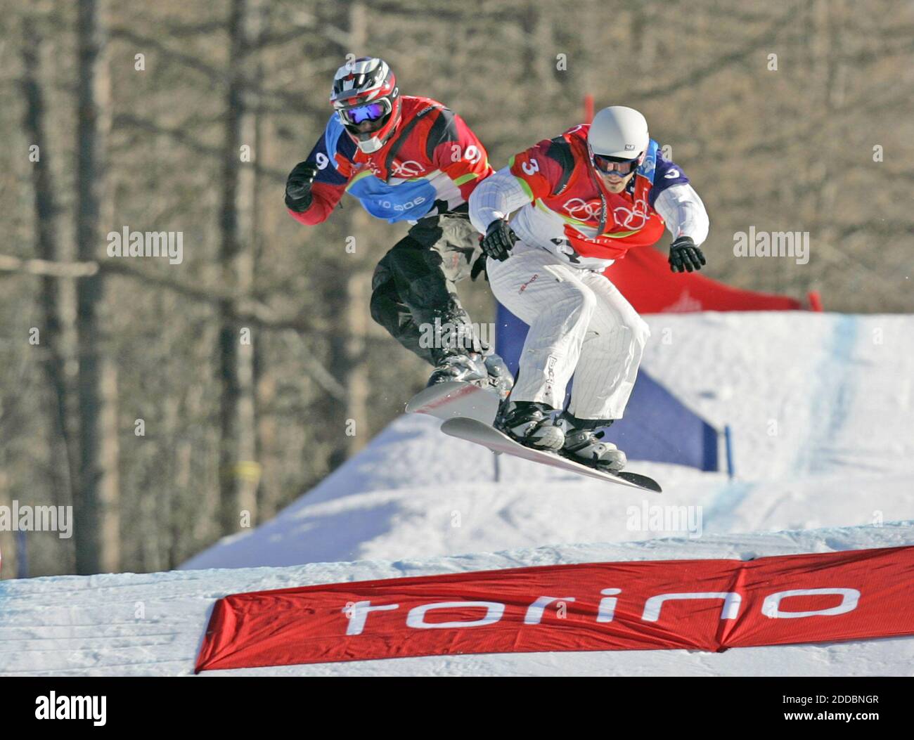 NO FILM, NO VIDEO, NO TV, NO DOCUMENTARY - Seth Wescott of the United States, right,soars toward the finish line for the first ever gold medal in snowboard-cross in Bardonecchia, at left is Radoslav Zidek of Slovakia who took the sliver at the XX Winter Olympic Games in Turin, Italy on February 16, 2006. Photo by Joe Rimkus Jr./Miami Herald/ KRT/Cameleon/ABACAPRESS.COM Stock Photo