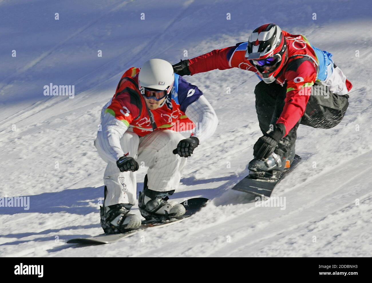 NO FILM, NO VIDEO, NO TV, NO DOCUMENTARY - Seth Wescott of the United States, left, nears the finish line for the first ever gold medal in snowboard-cross in Bardonecchia, at right is Radoslav Zidek of Slovakia who took the sliver, at the XX Winter Olympic Games in Turin, Italy on February 16, 2006. Photo by Joe Rimkus Jr./Miami Herald/ KRT/Cameleon/ABACAPRESS.COM Stock Photo