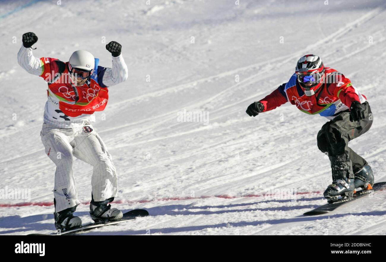 NO FILM, NO VIDEO, NO TV, NO DOCUMENTARY - Seth Wescott of the United States, left, crosses the finish line for the first ever gold medal in snowboard-cross in Bardonecchia, at right is Radoslav Zidek of Slovakia who took the sliver, in Bardonecchia, at the XX Winter Olympic Games in Turin, Italy on February 16, 2006. Photo by Joe Rimkus Jr./Miami Herald/ KRT/Cameleon/ABACAPRESS.COM Stock Photo
