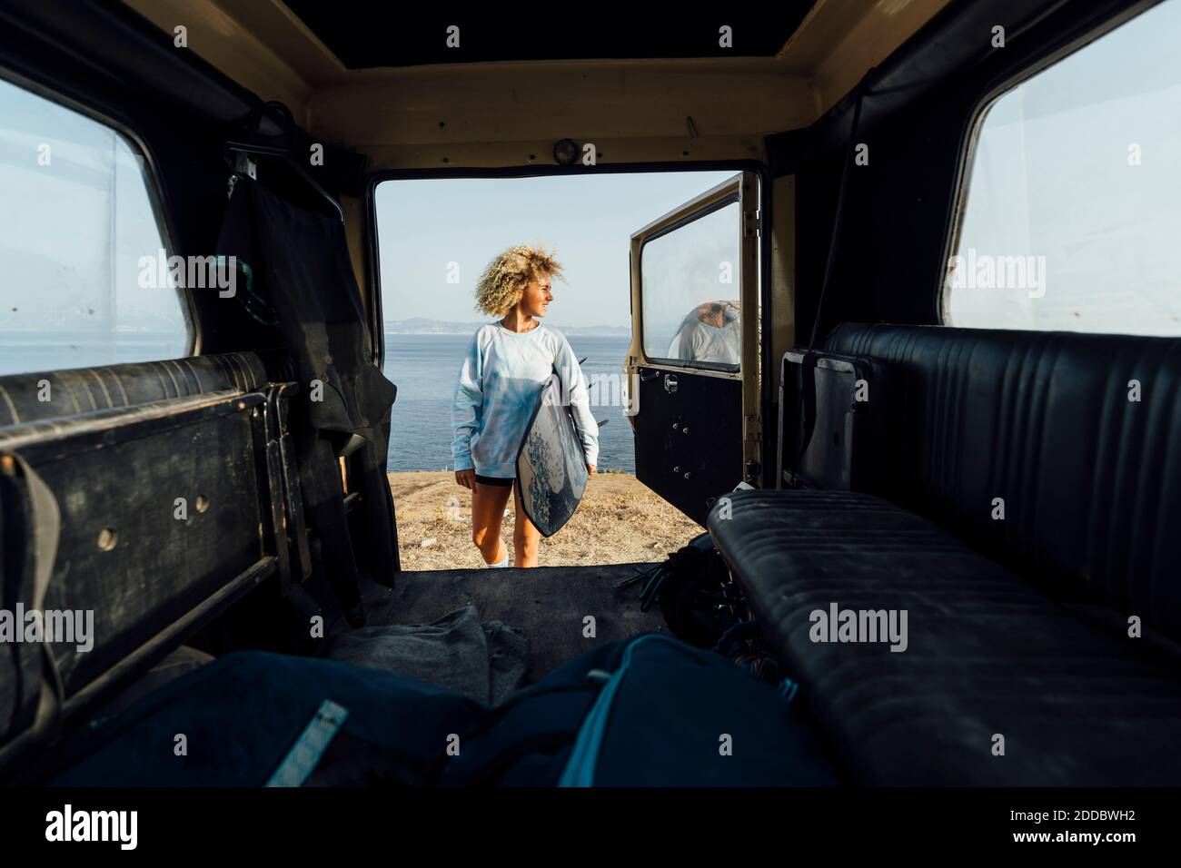 Woman holding surfboard hi-res stock photography and images - Alamy