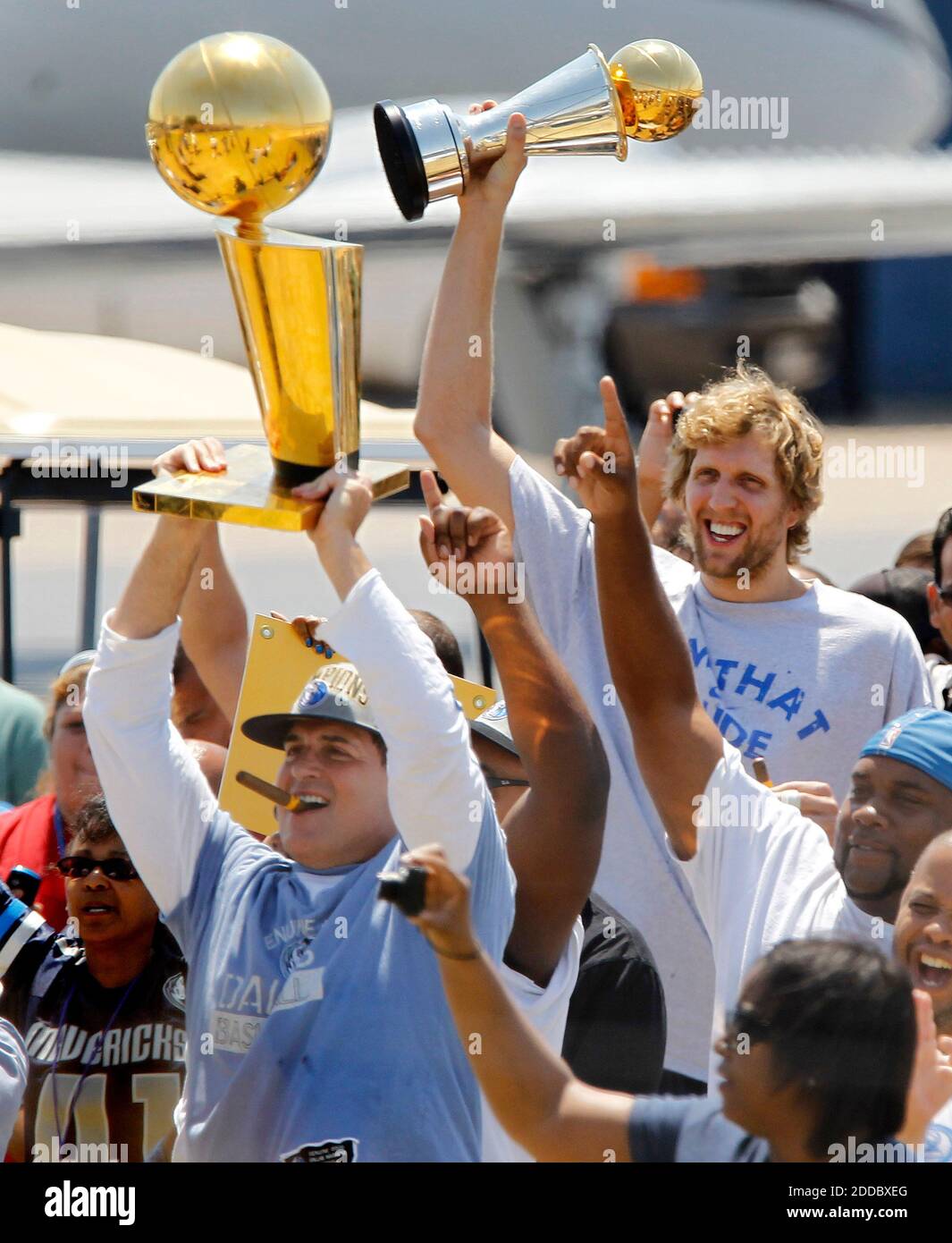 NO FILM, NO VIDEO, NO TV, NO DOCUMENTARY - Dallas Mavericks owner Mark Cuban, left, lifts the NBA Championship trophy as Dirk Nowitzki holds the MVP trophy after the team returned to Dallas Love Field, TX, USA on June 13, 2011, after defeating the Miami Heat in Game 6 of the NBA Finals on Sunday. Photo by Ron T. Ennis/Fort Worth Star-Telegram/MCT/ABACAPRESS.COM Stock Photo