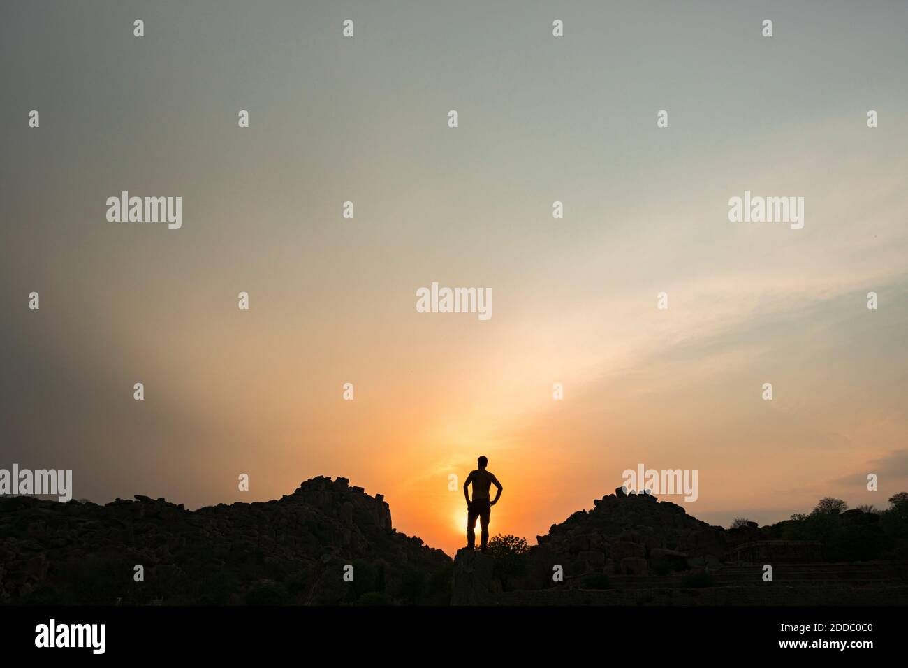 Silhouette of person admiring setting sun Stock Photo