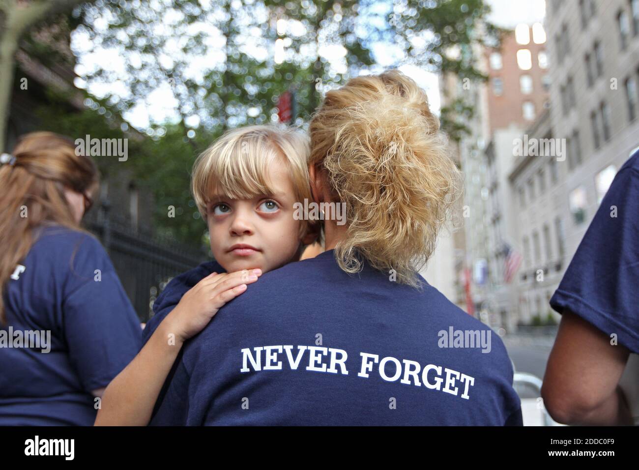 NO FILM, NO VIDEO, NO TV, NO DOCUMENTARY - Sean Geyer, 4 1/2, takes in the crowd at Ground Zero as his mother, Lorie Geyer, holds him close as they face Freedom Tower in New York City, Sunday, September 11, 2011, as the bells sound to mark the first plane crashing into the towers ten years ago. Photo by Michael Bryant/Philadelphia Inquirer/MCT/ABACAPRESS.COM Stock Photo