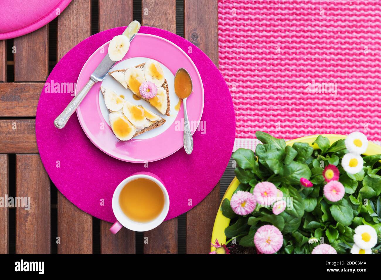 Mug of herb tea and bread slices with bananas and honey Stock Photo