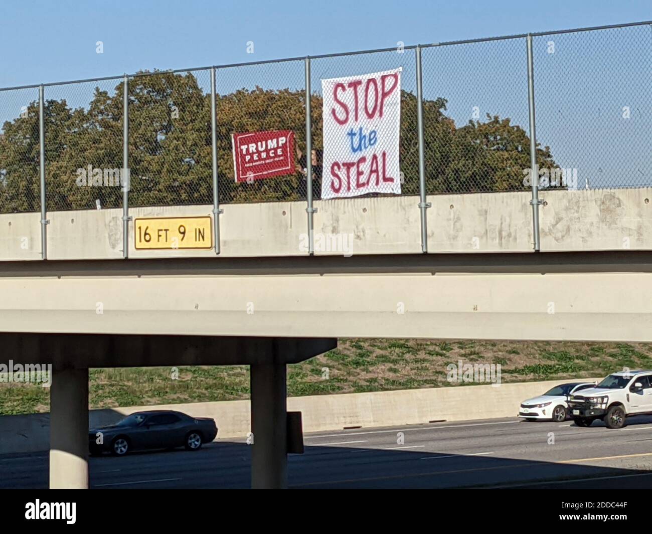 2020 elections are over, Trump supporters stand with President Trump it calling the election a fake, believe he won and mail-in ballots were all fake. They post a sign above a busy highway between Dallas and Fot Worth Texas. (Sign removed by police as a safety hazard) Stock Photo