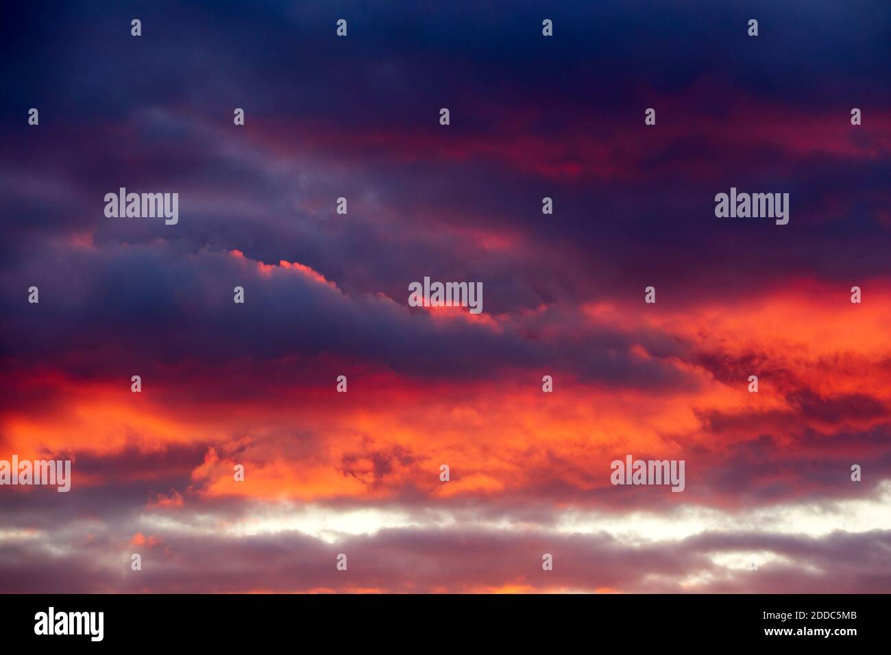 Dark clouds illuminated by setting sun Stock Photo