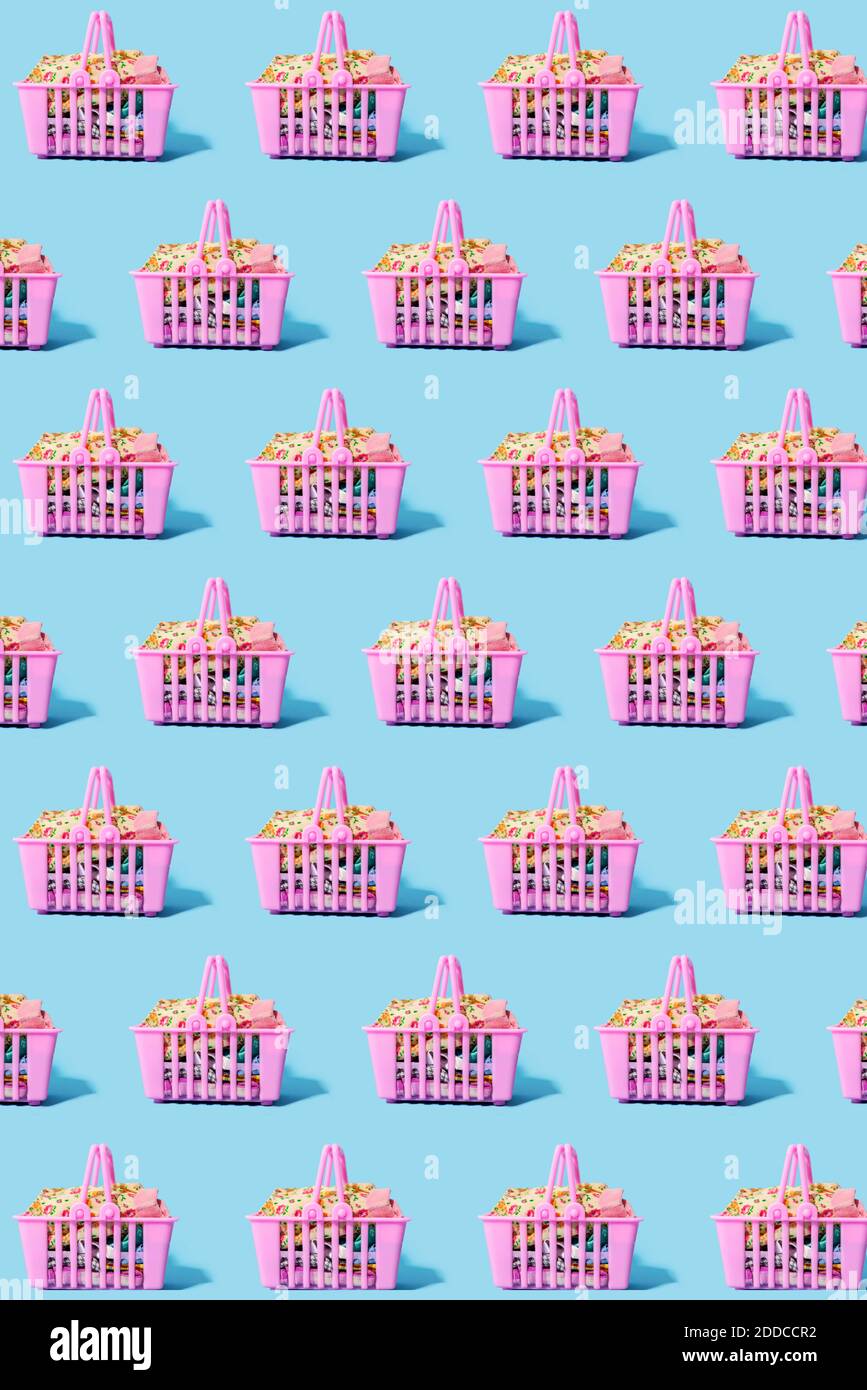 Pattern of pink shopping baskets filled with clothing Stock Photo