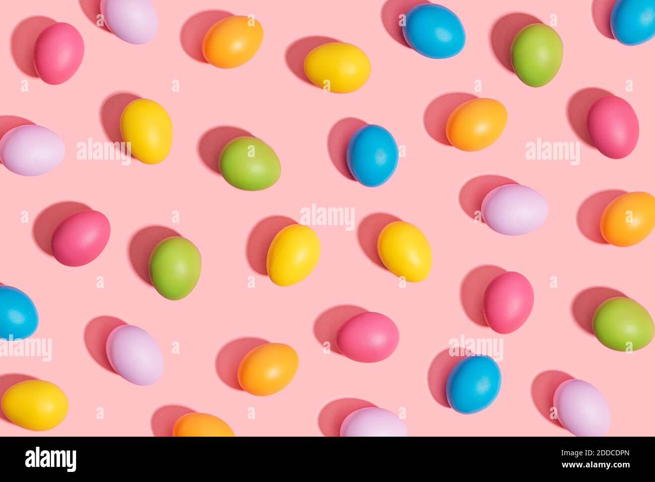 Multi colored easter eggs on pink background Stock Photo