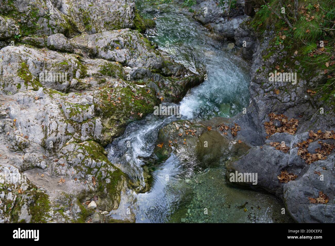 Weissach river flowing through rocky terrain in Kreuther Tal Stock Photo