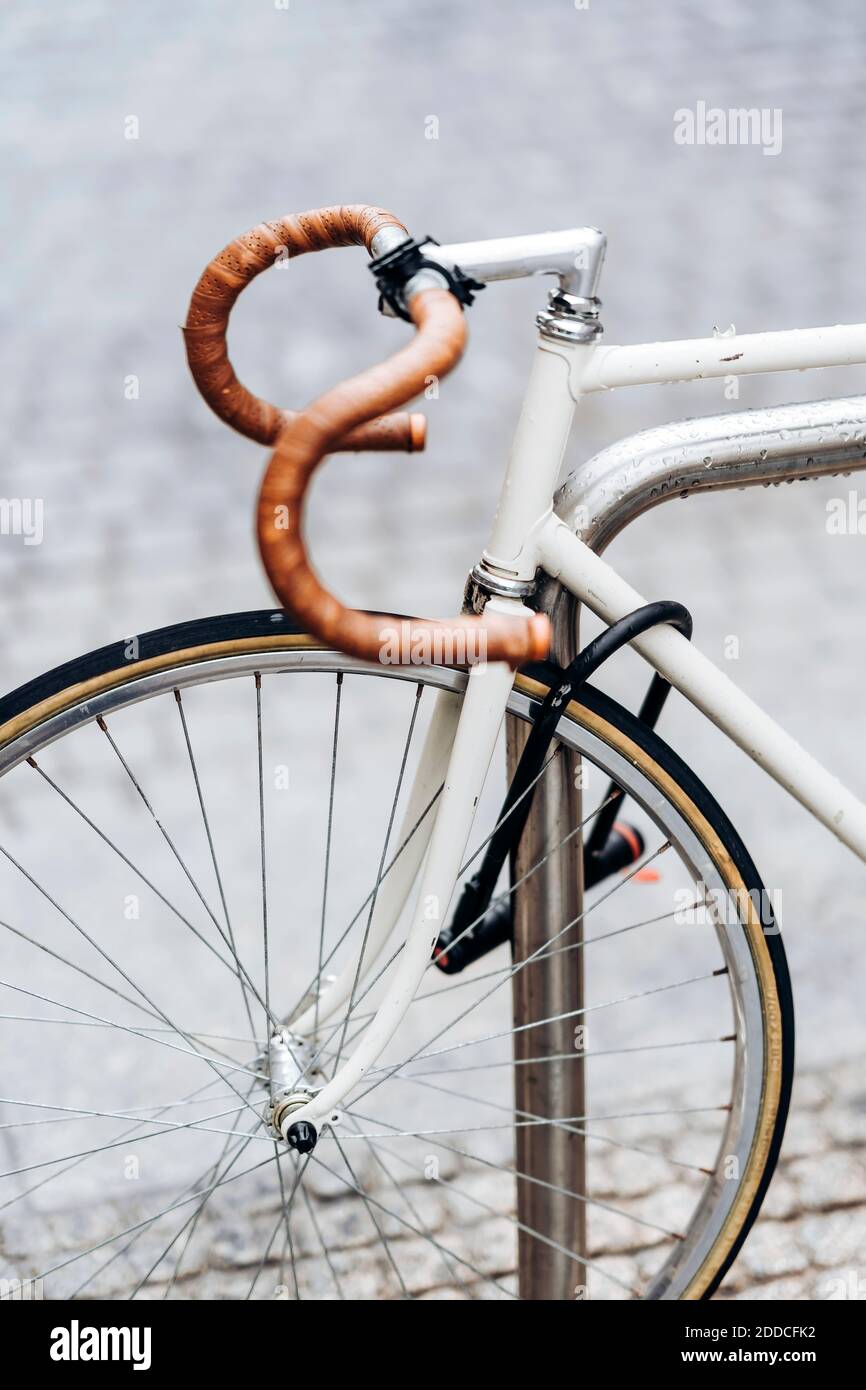 Racing bicycle locked to bicycle rack Stock Photo