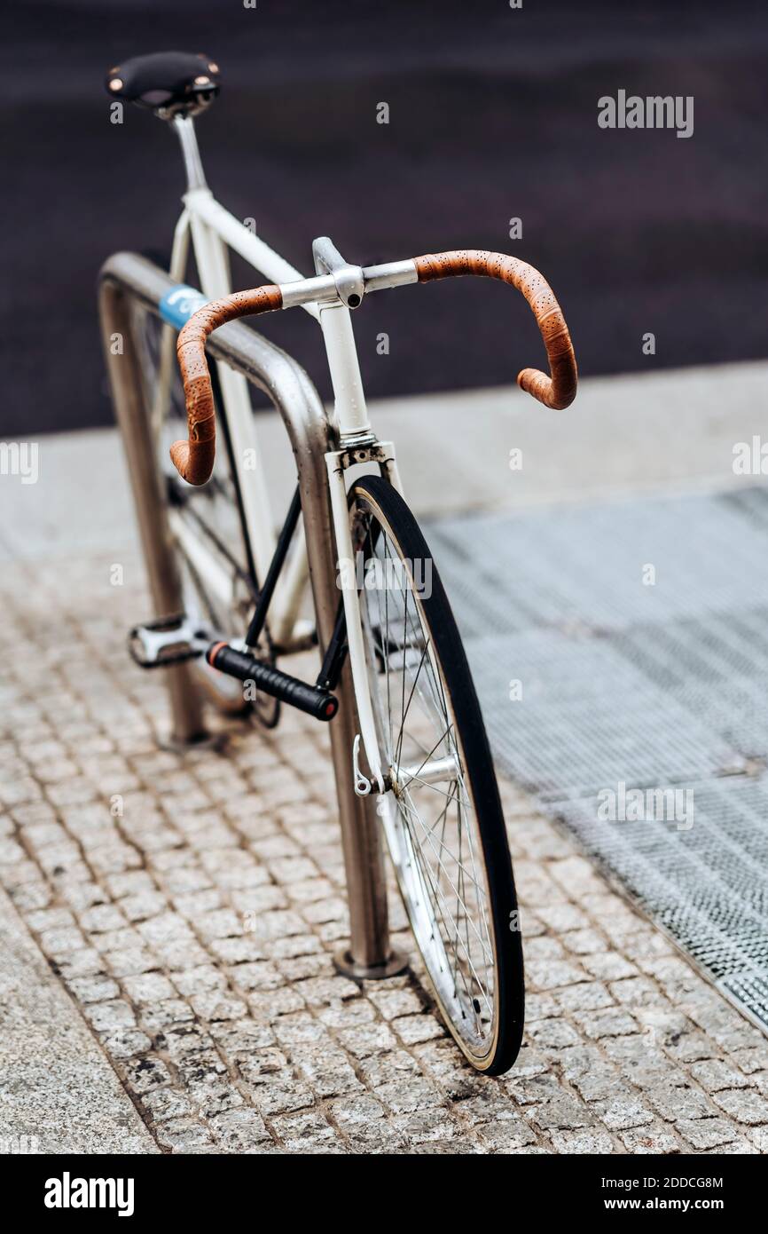Racing bicycle locked to bicycle rack Stock Photo