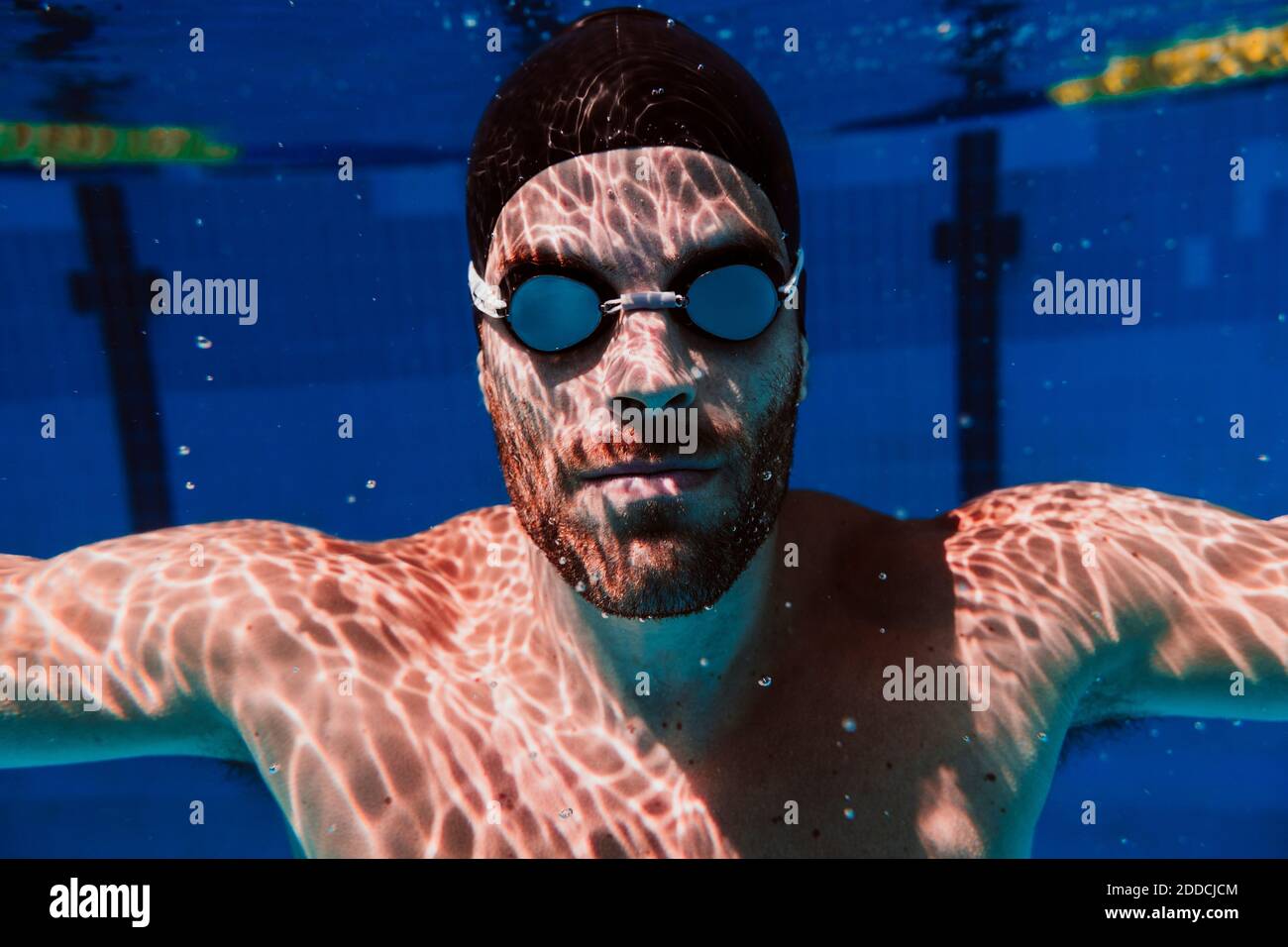 Young male swimmer swimming underwater in pool Stock Photo - Alamy