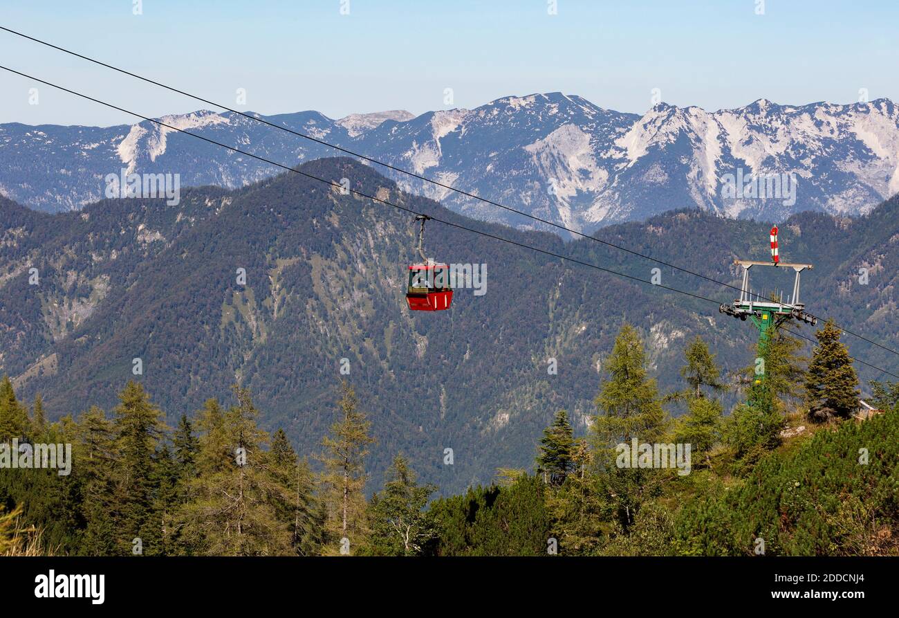 Austria, Upper Austria, Bad Ischl, Overhead cable car moving over forested mountain valley Stock Photo