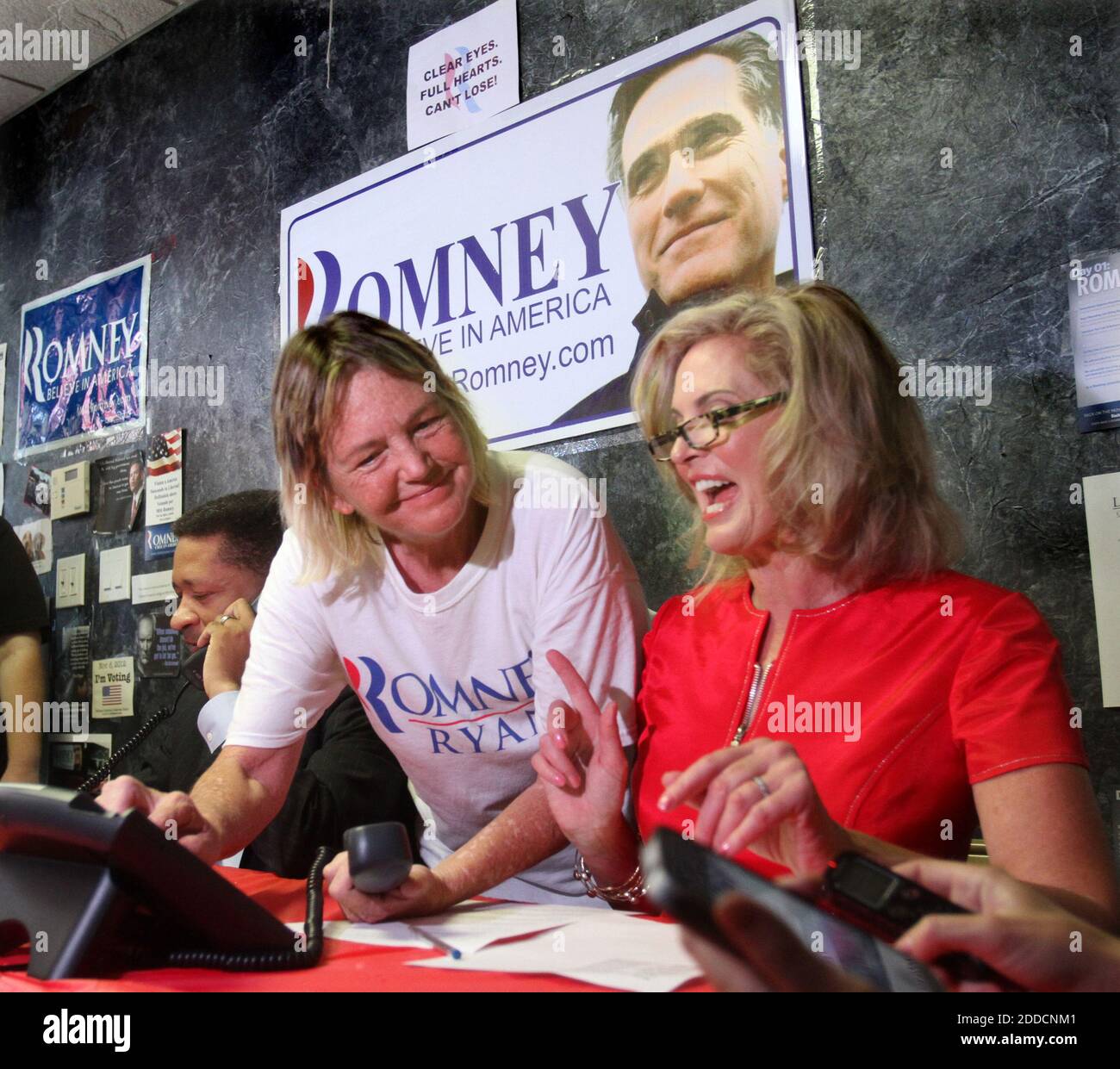 NO FILM, NO VIDEO, NO TV, NO DOCUMENTARY - Ann Romney, wife of Republican  presidential nominee Mitt Romney, gets help from volunteer Sarah Frazee,  center, as she works the phones with Artur