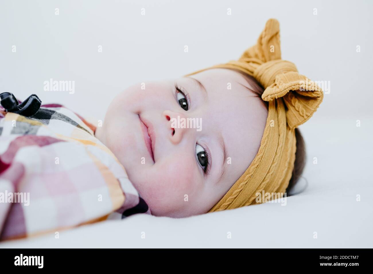 Baby girl lying on bed hi-res stock photography and images - Alamy
