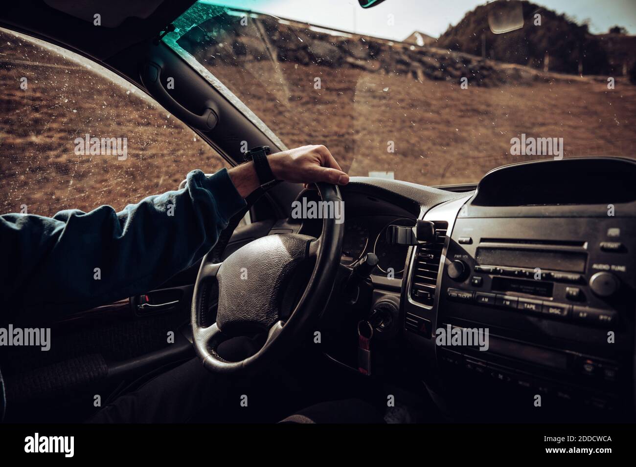 Arm of young man driving SUV Stock Photo