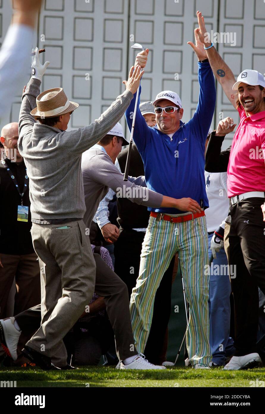 NO FILM, NO VIDEO, NO TV, NO DOCUMENTARY - At center, musician Huey Lewis is congratulated by Jake Owen, right, Andy Garcia, left, and Josh Duhamel, center left, after winning the chip-off during the $100,000 celebrity charity shoot-out golf match at the AT&T Pebble Beach National Pro-Am in Pebble Beach, CA, USA on February 6, 2013. Photo by LiPo Ching/San Jose Mercury News/MCT/ABACAPRESS.COM Stock Photo