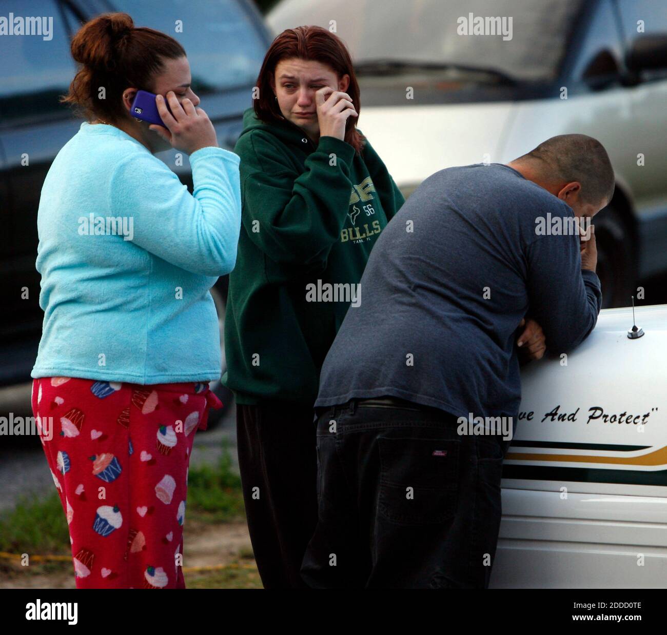 NO FILM, NO VIDEO, NO TV, NO DOCUMENTARY - Jeremy Bush, right, waits at the scene of his home, in Seffner, Florida, Friday, March 1, 2013. A Florida man was feared dead after a sinkhole suddenly opened up under the bedroom of his suburban Tampa home and swallowed him, police and fire officials said. Rescuers responded to a 911 call late on Thursday after the family of Jeff Bush, 36, reported hearing a loud crash in the house and rushed to his bedroom. Photo by Skip O'Rourke/Tampa Bay Times/MCT/ABACAPRESS.COM Stock Photo