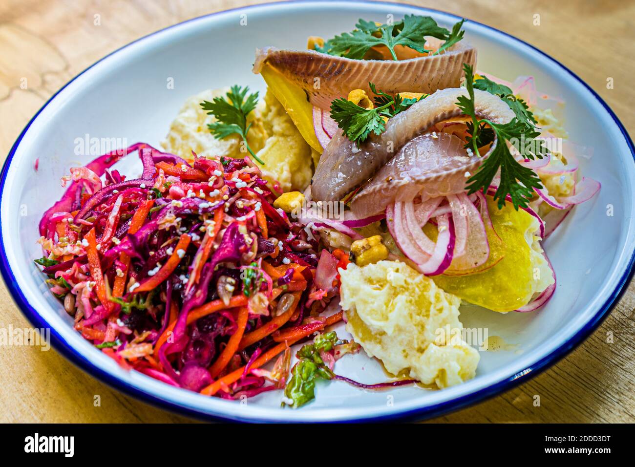 Ceviche St. Heinrich, a potato salad with wasabi and yoghurt dressing, fish from Lake Starnberg, marinated beets, fried corn, onions and tiger milk in München, Germany Stock Photo