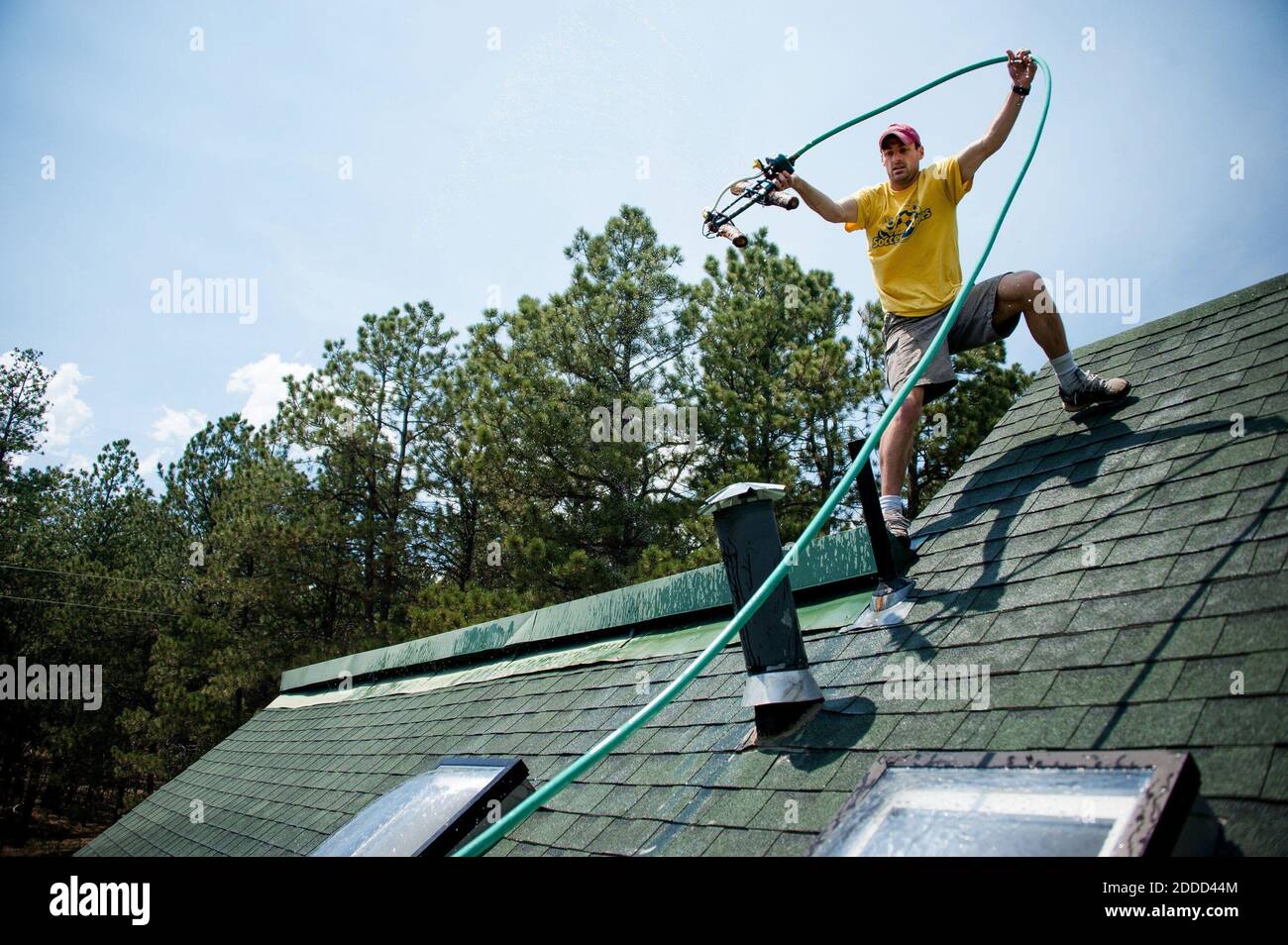 NO FILM, NO VIDEO, NO TV, NO DOCUMENTARY - Sean Collins moved a sprinkler on his roof before leaving the area after a mandatory evacuation that was ordered for the communities east of Highway 83, as the Black Forest fire pushes closer to the area, Thursday, June 13, 2013, in Colorado Springs, Colorado, USA. Photo by Michael Ciaglo/Colorado Springs Gazette/MCT/ABACAPRESS.COM Stock Photo