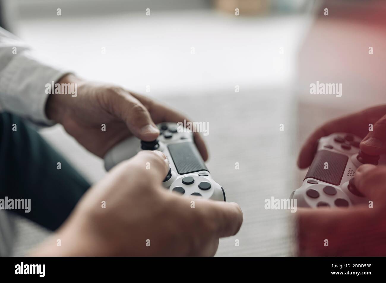 Businessman hands holding video game remote control at office Stock