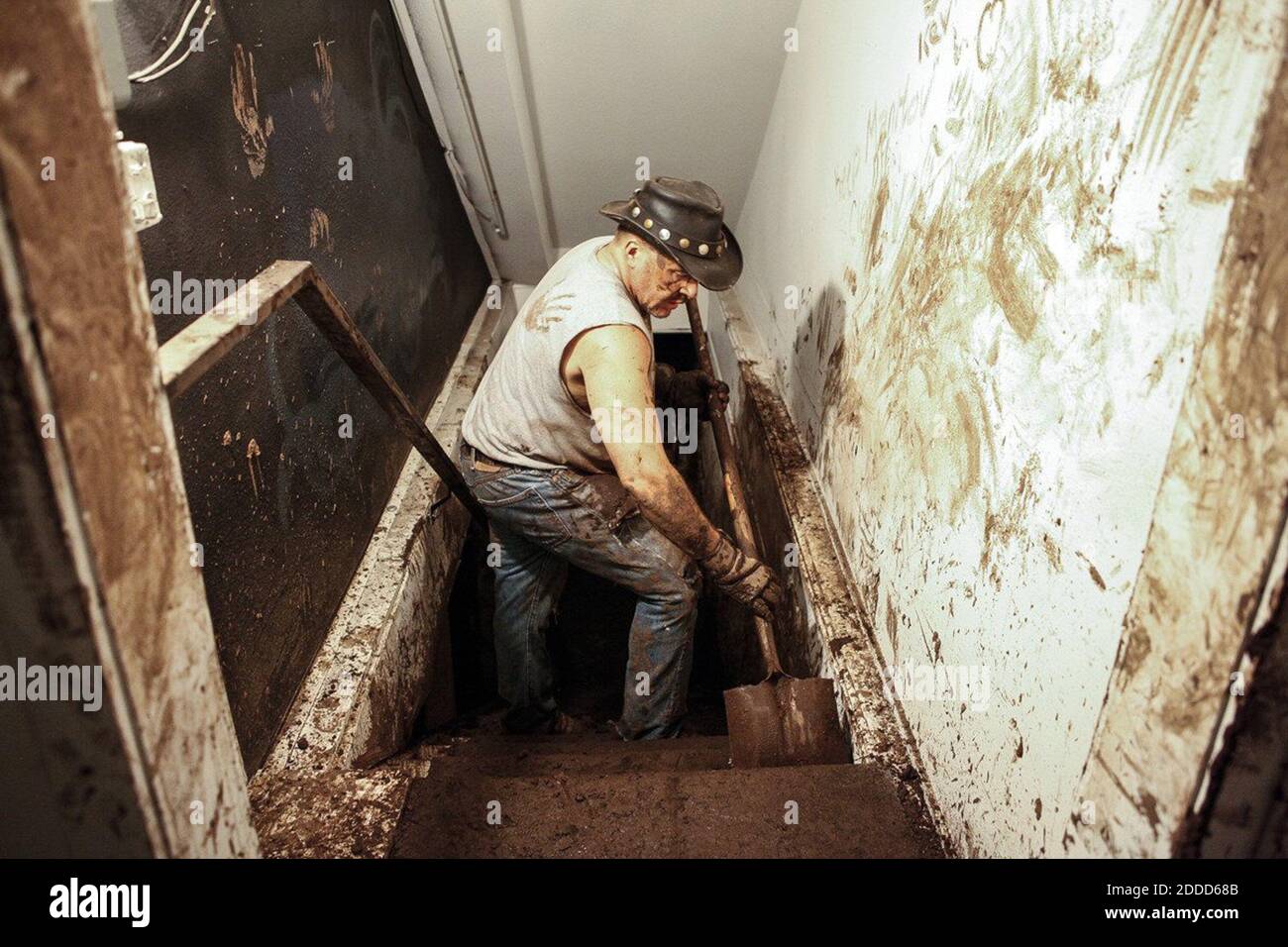 NO FILM, NO VIDEO, NO TV, NO DOCUMENTARY - Volunteer J Gorman cleans the stairs to the basement in a building on Canyon Road in Manitou Springs, Colorado, Sunday, August 11, 2013. Photo by Junfu Han/Colorado Springs Gazette/MCT/ABACAPRESS.COM Stock Photo
