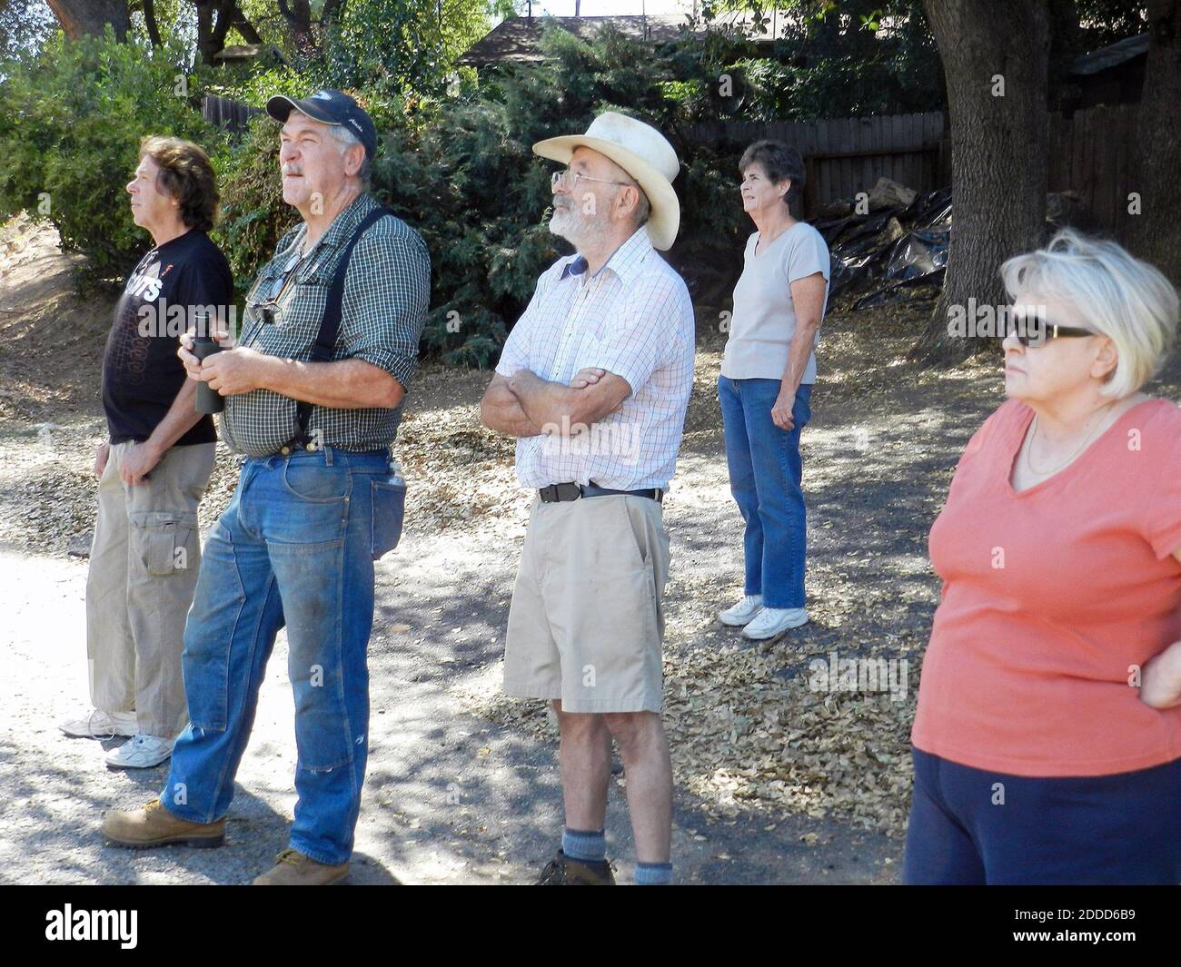 NO FILM, NO VIDEO, NO TV, NO DOCUMENTARY - Mike Sanders, 2nd from left, Rick Jerome, center, and Susan Starr, far right, watch the Rim fire with other neighbors in front of Starr's home on Canyon Drive near Tuolumne City, California, USA, Sunday, August 25, 2013. Photo by Jeff Jardine/Modesto Bee/MCT/ABACAPRESS.COM Stock Photo