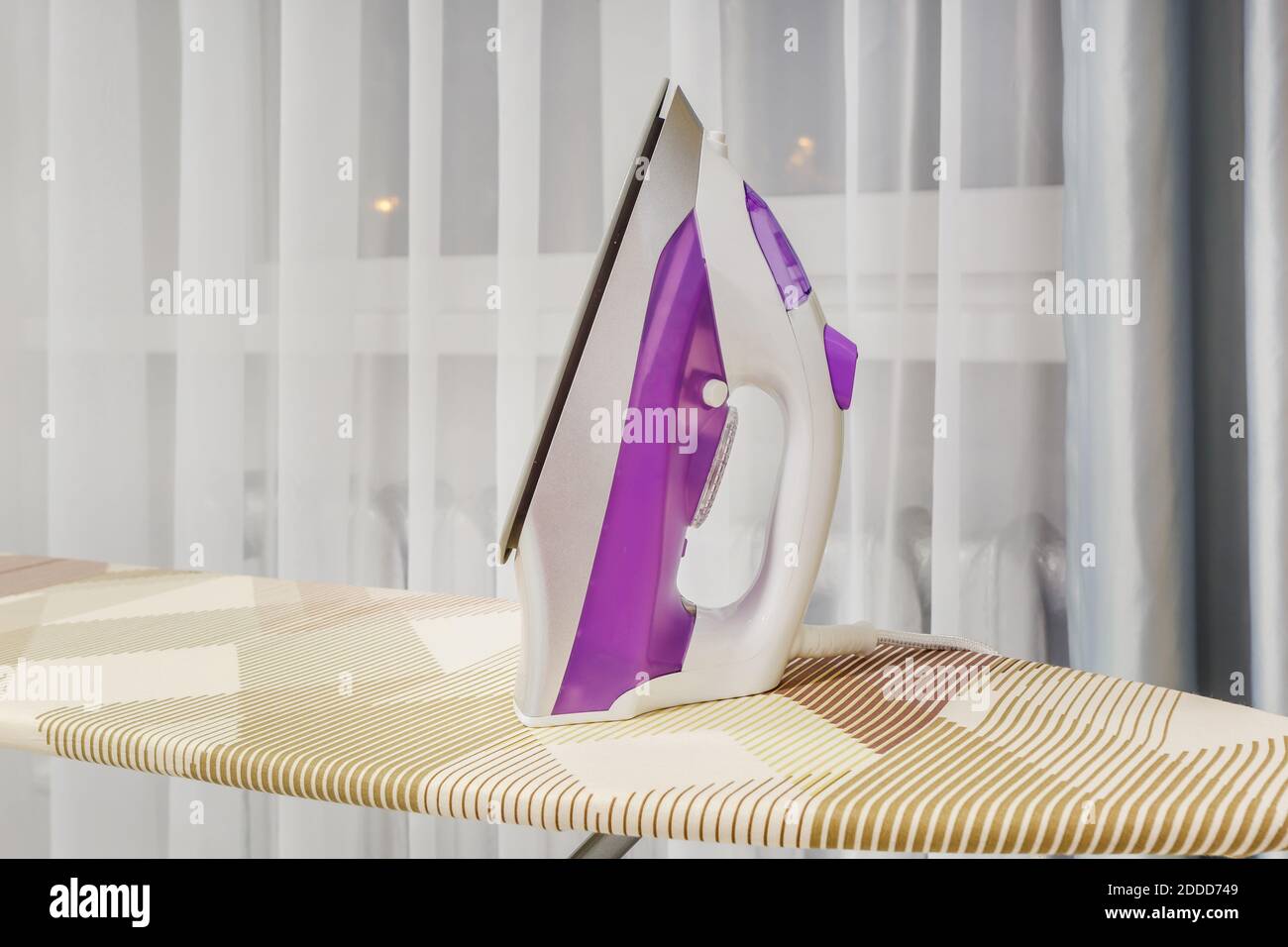 modern iron on ironing board Stock Photo