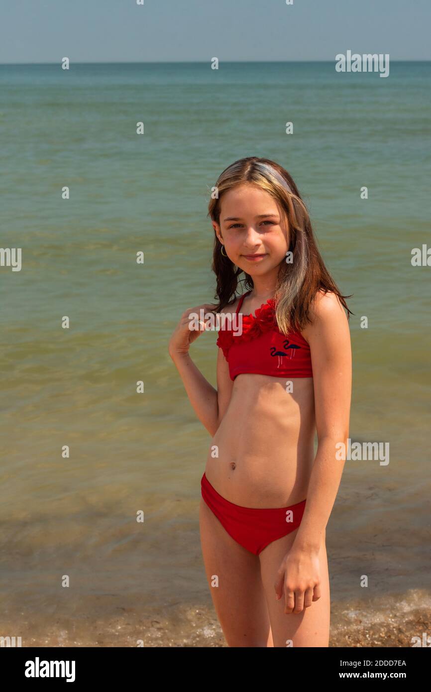 Girl child in swimsuit near the sea, the concept of rest and vacation.  Teenage girl near the sea Stock Photo - Alamy
