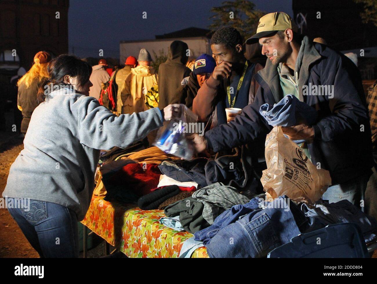 NO FILM, NO VIDEO, NO TV, NO DOCUMENTARY - Volunteer Jackie Peck, left, hands out clothing to homeless men, Oct. 21, 2013, near the St. Louis riverfront. Photo by J.B. Forbes/St. Louis Post-Dispatch/MCT/ABACAPRESS.COM Stock Photo