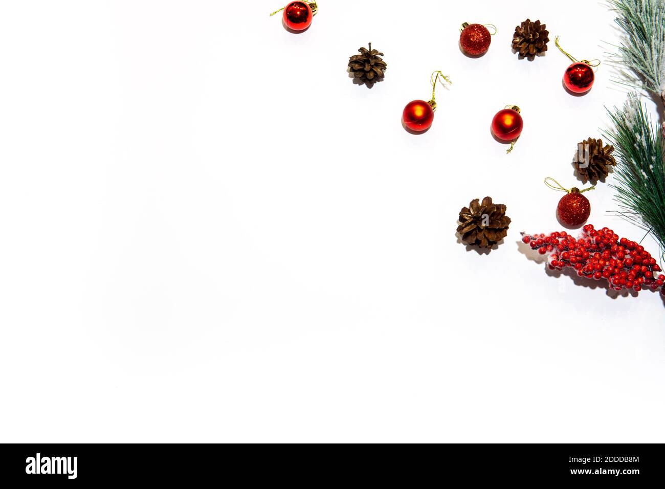 Christmas composition. Red decorations with pines on white background. Christmas, winter, new year concept. Flat lay. Stock Photo