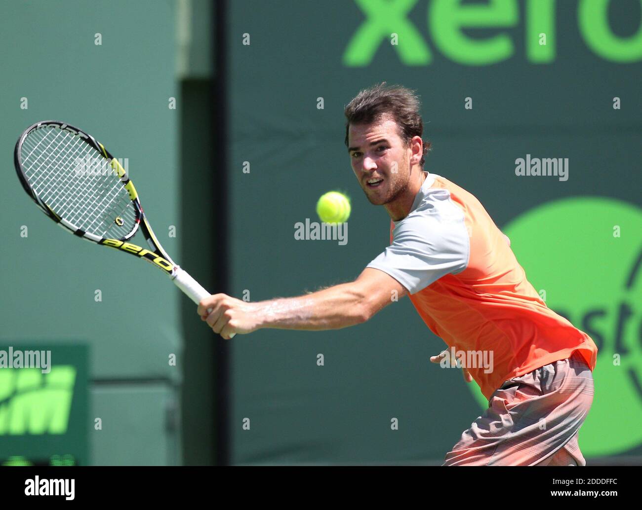 NO FILM, NO VIDEO, NO TV, NO DOCUMENTARY - Adrian Mannarino of France  returns a ball to Nikolay Davydenko of Russia during a first-round match at  the Sony Open tennis tournament at