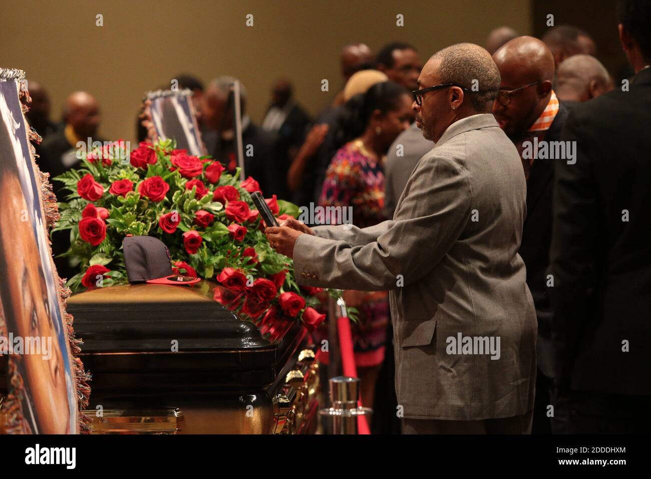 NO FILM, NO VIDEO, NO TV, NO DOCUMENTARY - Director Spike Lee takes a picture of a black St. Louis Cardinals baseball cap on top of Michael Brown's casket on Monday, Aug. 25, 2014, during the funeral services at Friendly Temple Missionary Baptist Church in St. Louis, MO, USA,. Michael Brown, 18, was shot and killed by a Ferguson police officer on Aug. 9, 2014. Photo by Robert Cohen/St. Louis Post-Dispatch/MCT/ABACAPRESS.COM Stock Photo