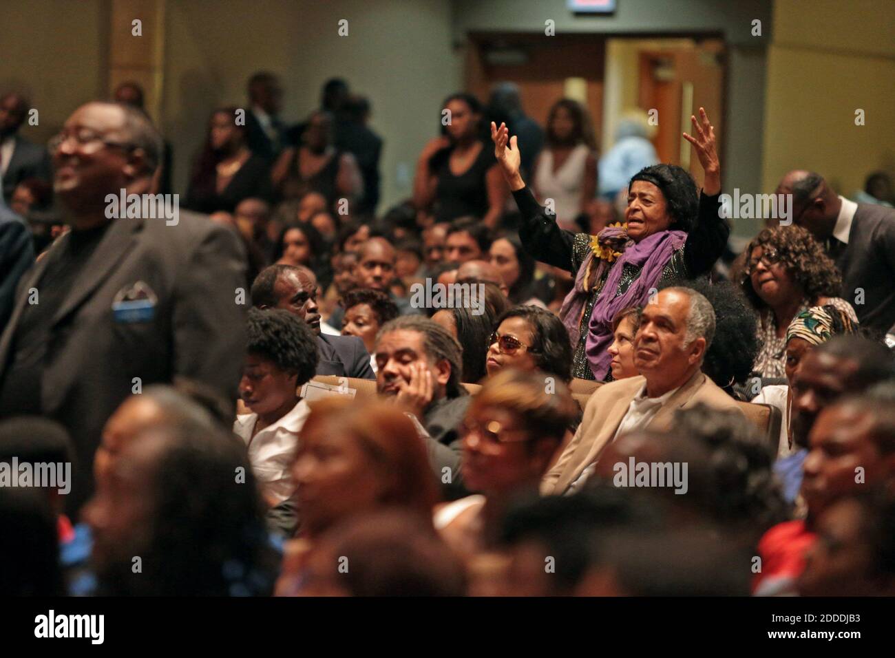NO FILM, NO VIDEO, NO TV, NO DOCUMENTARY - A woman rises to her feet during the funeral services for Michael Brown on Monday, Aug. 25, 2014, at Friendly Temple Missionary Baptist Church in St. Louis. Michael Brown, 18, was shot and killed by a Ferguson police officer on August 9, 2014. Photo by Robert Cohen/St. Louis Post-Dispatch/MCT/ABACAPRESS.COM Stock Photo