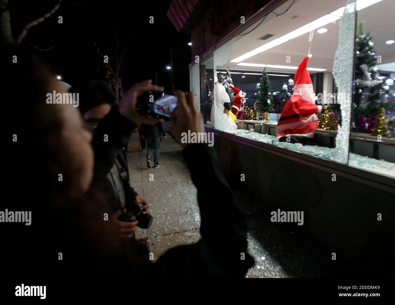 NO FILM, NO VIDEO, NO TV, NO DOCUMENTARY - A deflated Santa Claus decoration hangs in the broken window of a Shattuck Avenue drugstore in Berkeley, CA, USA,, early Monday morning, December 8, 2014, after a second wave of protesting over the killings of two unarmed black men by police in Ferguson, Mo., and New York. Photo by Karl Mondon/Bay Area News Group/TNS/ABACAPRESS.COM Stock Photo