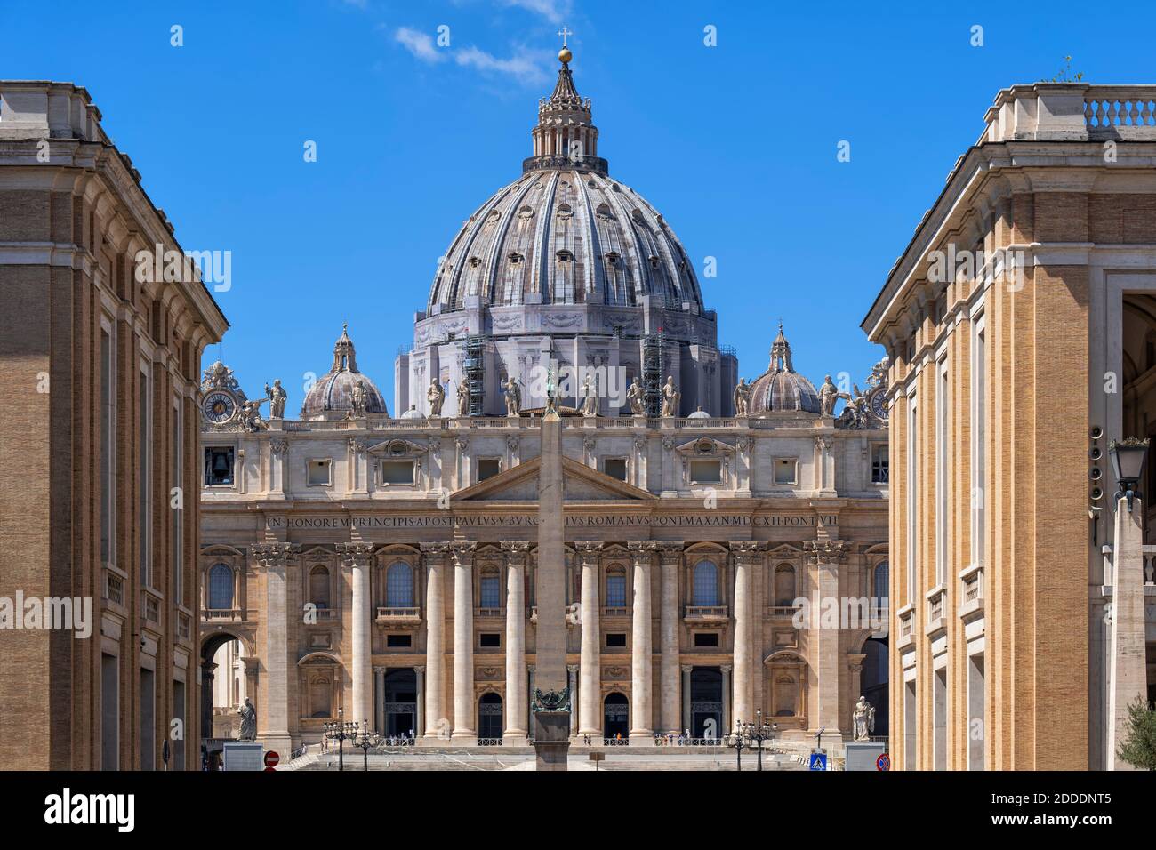 St. Peter's Basilica in city against blue sky on sunny day Stock Photo