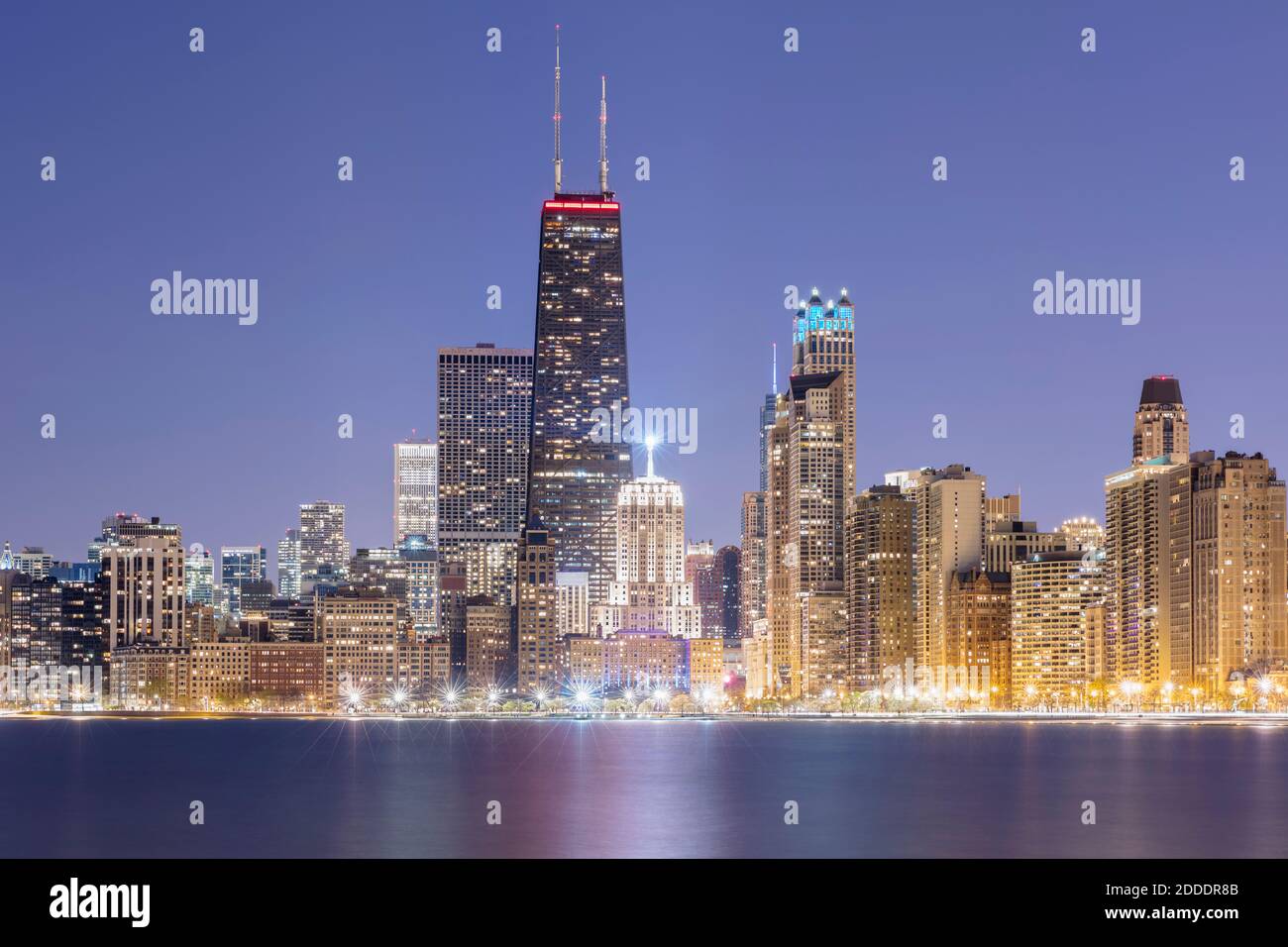 Illuminated view of 875 North Michigan Avenue (John Hancock Center) surrounded by skyscrapers at dusk, Chicago, USA Stock Photo