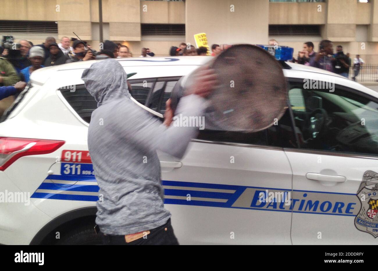NO FILM, NO VIDEO, NO TV, NO DOCUMENTARY - A protestor smashes the window of a Baltimore police vehicle on Saturday, April 25, 2015, as protests continue in the wake of Freddie Gray's death while in police custody. Photo by Colin Campbell/Baltimore Sun/TNS/ABACAPRESS.COM Stock Photo